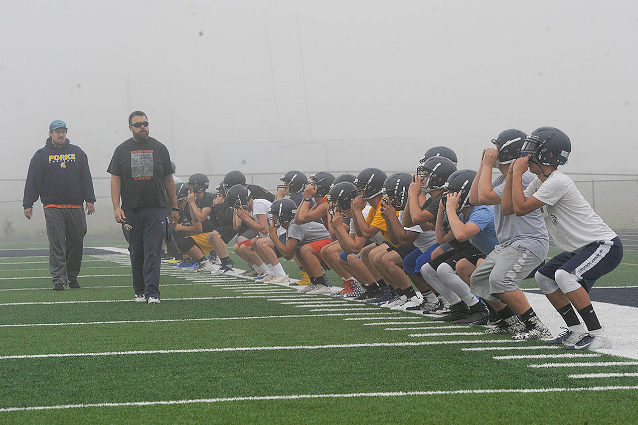 Lonnie Archibald/for Peninsula Daily News Forks football players warm up during their first of two practices Wednesday, the opening day of the prep football season.