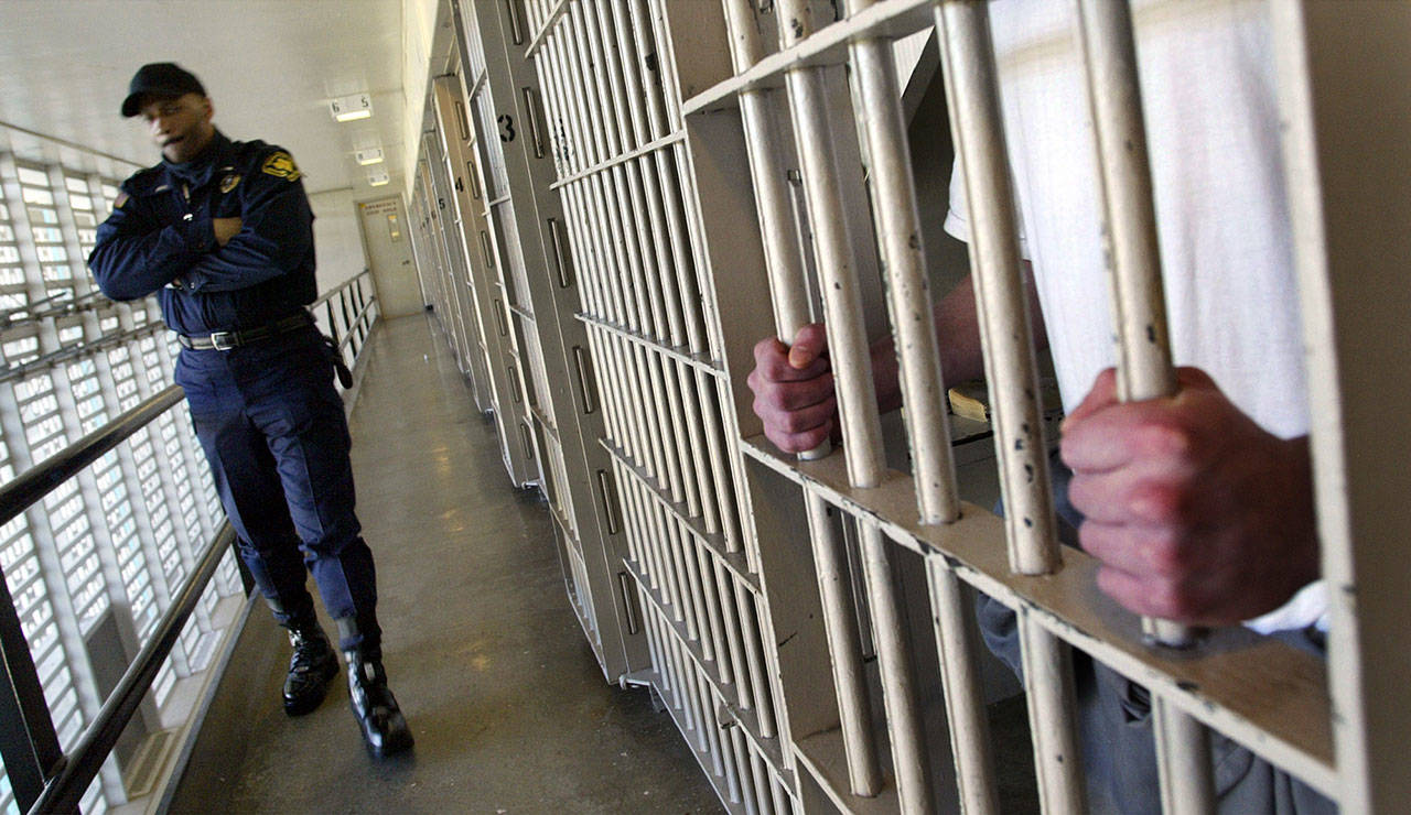 In this Feb. 2, 2005, file photo Washington state prisons Lt. Clan Jacobs walks through a block of cells at the Washington Corrections Center in Shelton. (The Associated Press)