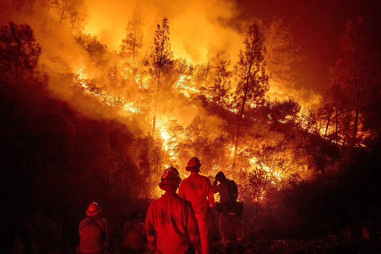 On Aug. 7, firefighters monitor a backfire while battling the Ranch Fire, part of the Mendocino Complex Fire near Ladoga, Calif. (Noah Berger/The Associated Press)