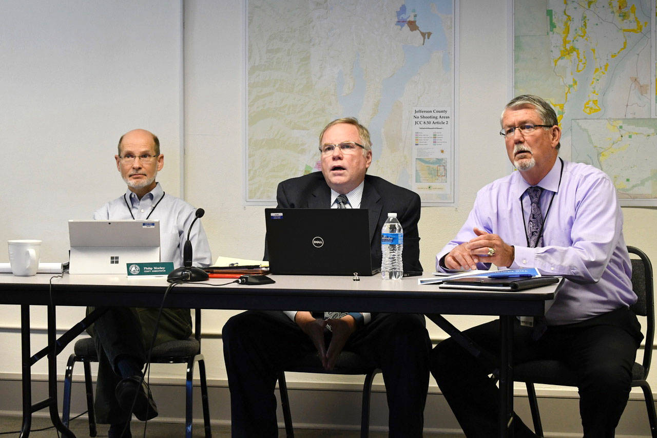 Chief Civil Deputy Prosecuting Attorney Philip Hunsucker, center, presented an overview of the Draft commercial shooting facility ordinance to the Jefferson County Board of Commissioners with Central Services Director Mark McCauley, right, who chaired the review committee. County Administrator Philip Morley also participated in the discussion. (Jeannie McMacken/Peninsula Daily News)