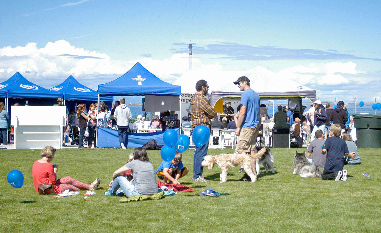 Families and their four-legged friends congregrate in the grass at Waterfront Park in downtown Port Angeles during Jammin’ in the Park in 2016. (Peninsula Daily News)