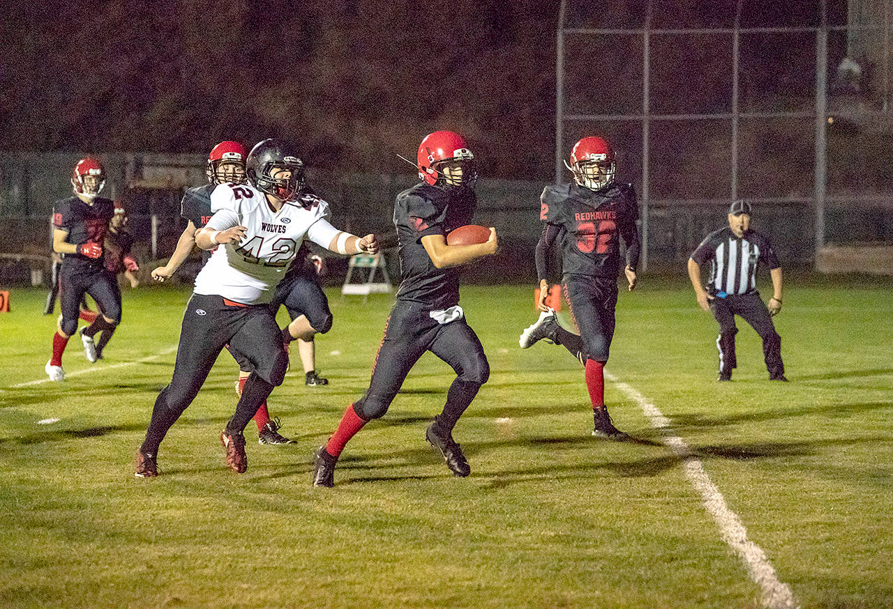 Steve Mullensky/for Peninsula Daily News Port Townsend freshman quarterback Tanner Woodley scampers for a touchdown against the Coupeville Wolves at Memorial Field in Port Townsend.