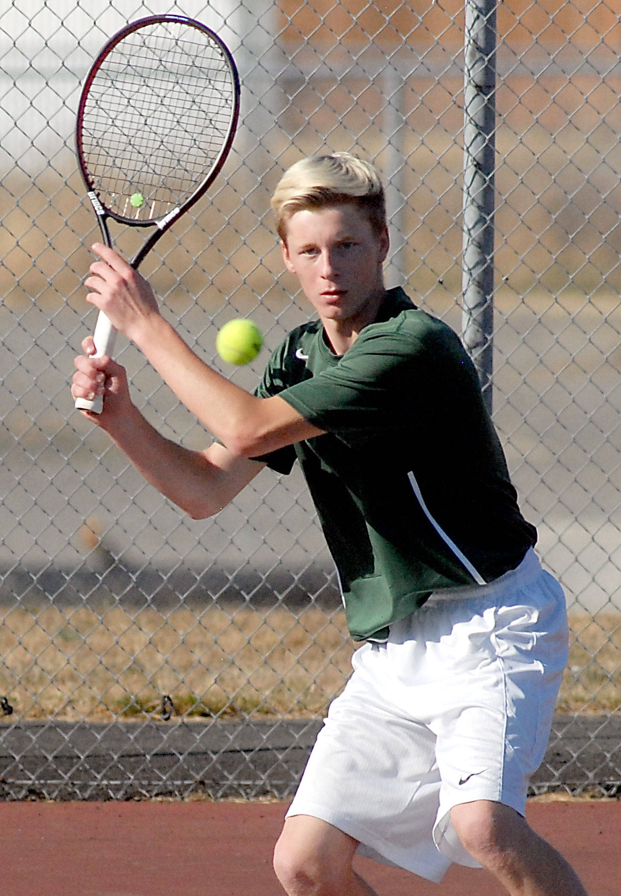 Keith Thorpe/Peninsula Daily News Port Angeles’ Hayden Woods takes aim in his singles match against Chimacum’s Jonah Diehl on Tuesday at Port Angeles High School.