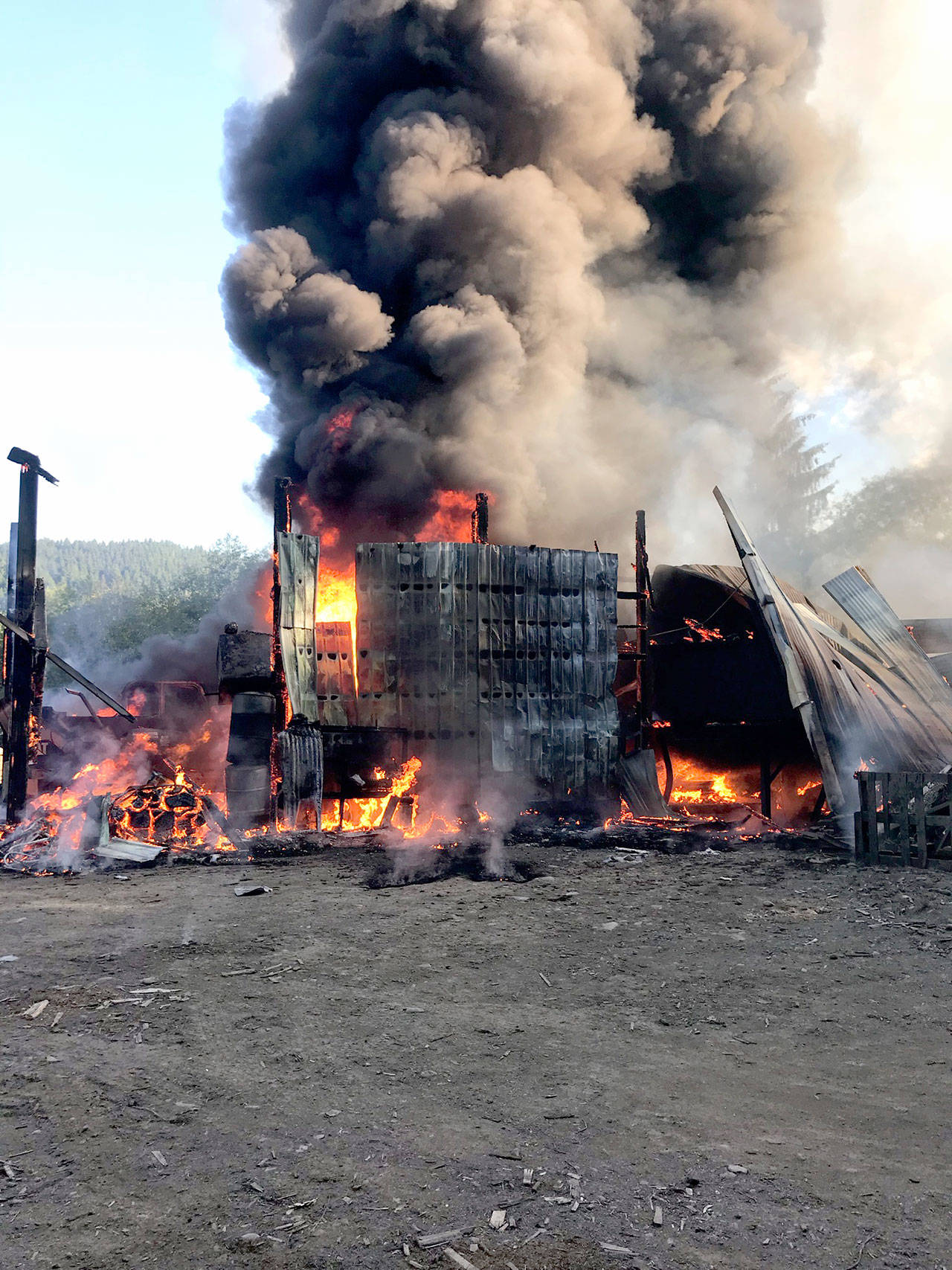 The cedar shake mill at 185183 U.S. Highway 101 south of Forks burns Wednesday morning. (Bill Paul/Clallam County Fire District No. 1)