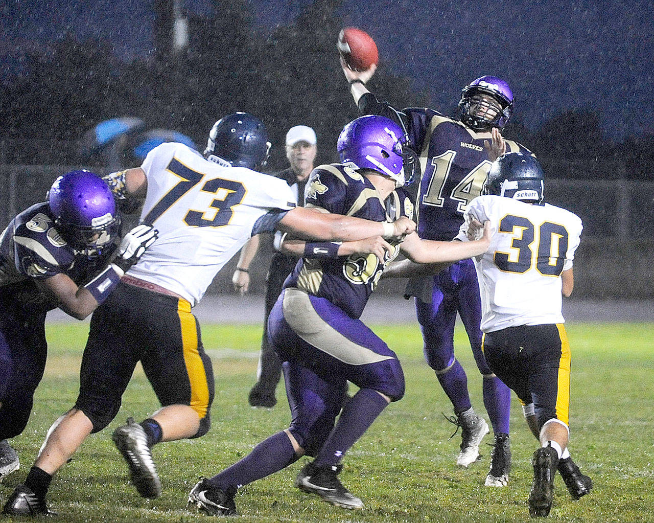 Sequim’s Riley Cowan (14) throws over the Forks defense while leading the Wolves back from a 16-0 deficit to win 20-16. (Michael Dashiell/Olympic Peninsula News Group)