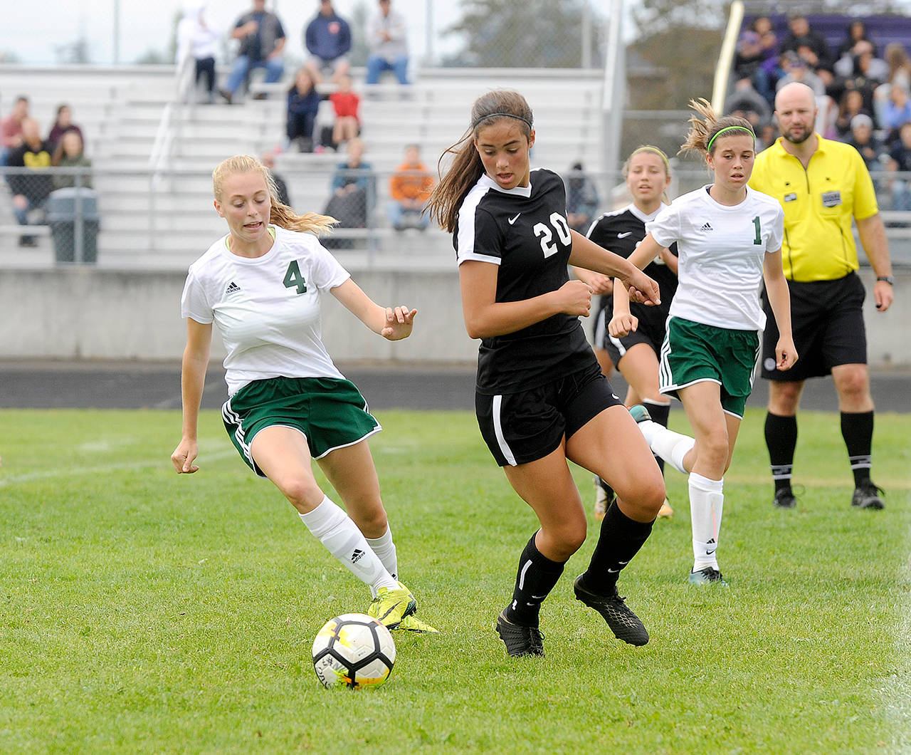 Michael Dashiell/Olympic Peninsula News Group Sequim’s Hope Glasser (20) vies for the ball with Port Angeles’ Teagan Clark in the first half of the Roughriders’ 3-0 victory on Saturday.