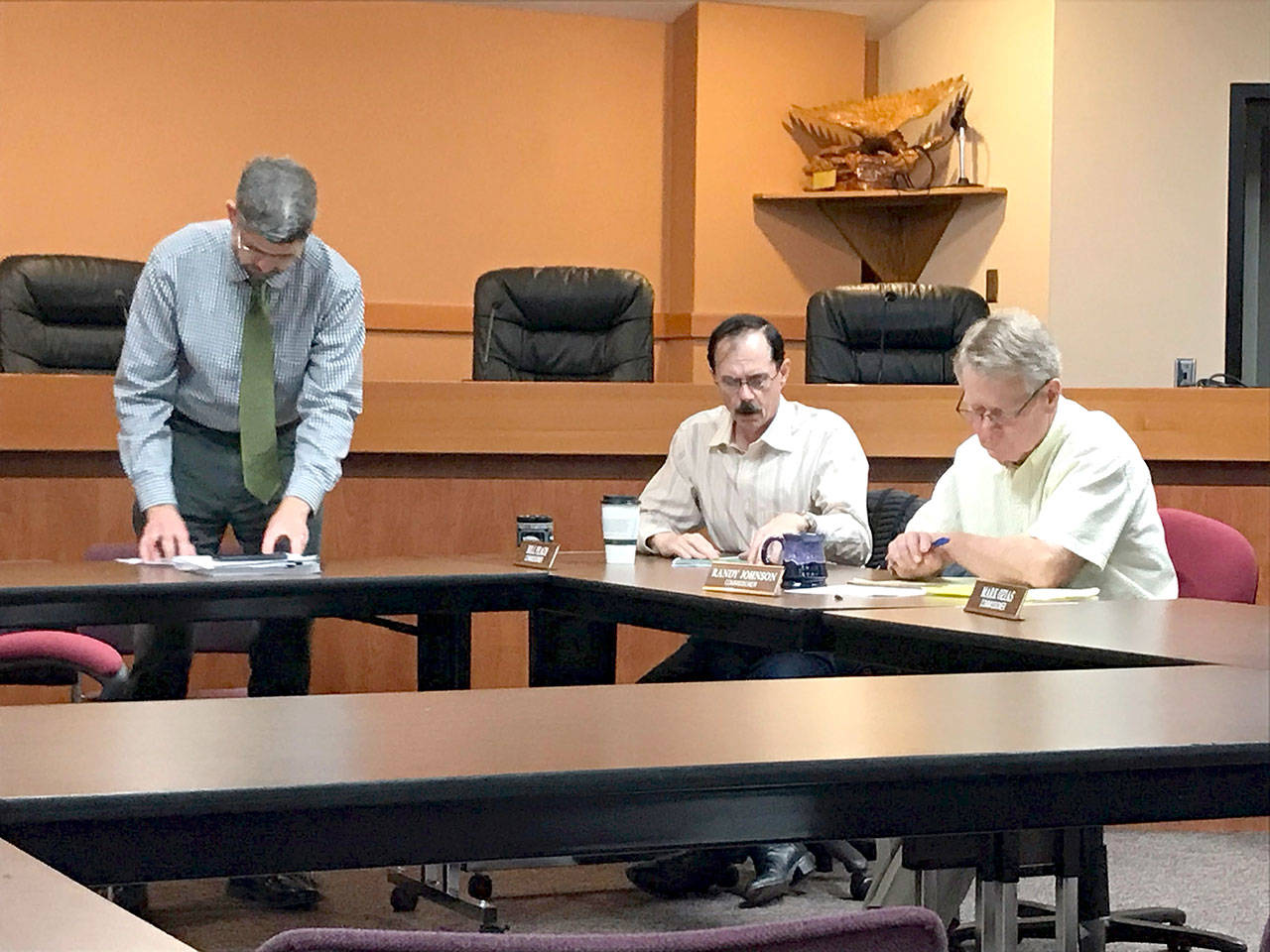Clallam County Commissioners, from left, Mark Ozias, Bill Peach and Randy Johnson before their brief meeting Friday at which they chose a new county administrator. (Paul Gottlieb/Peninsula Daily News)