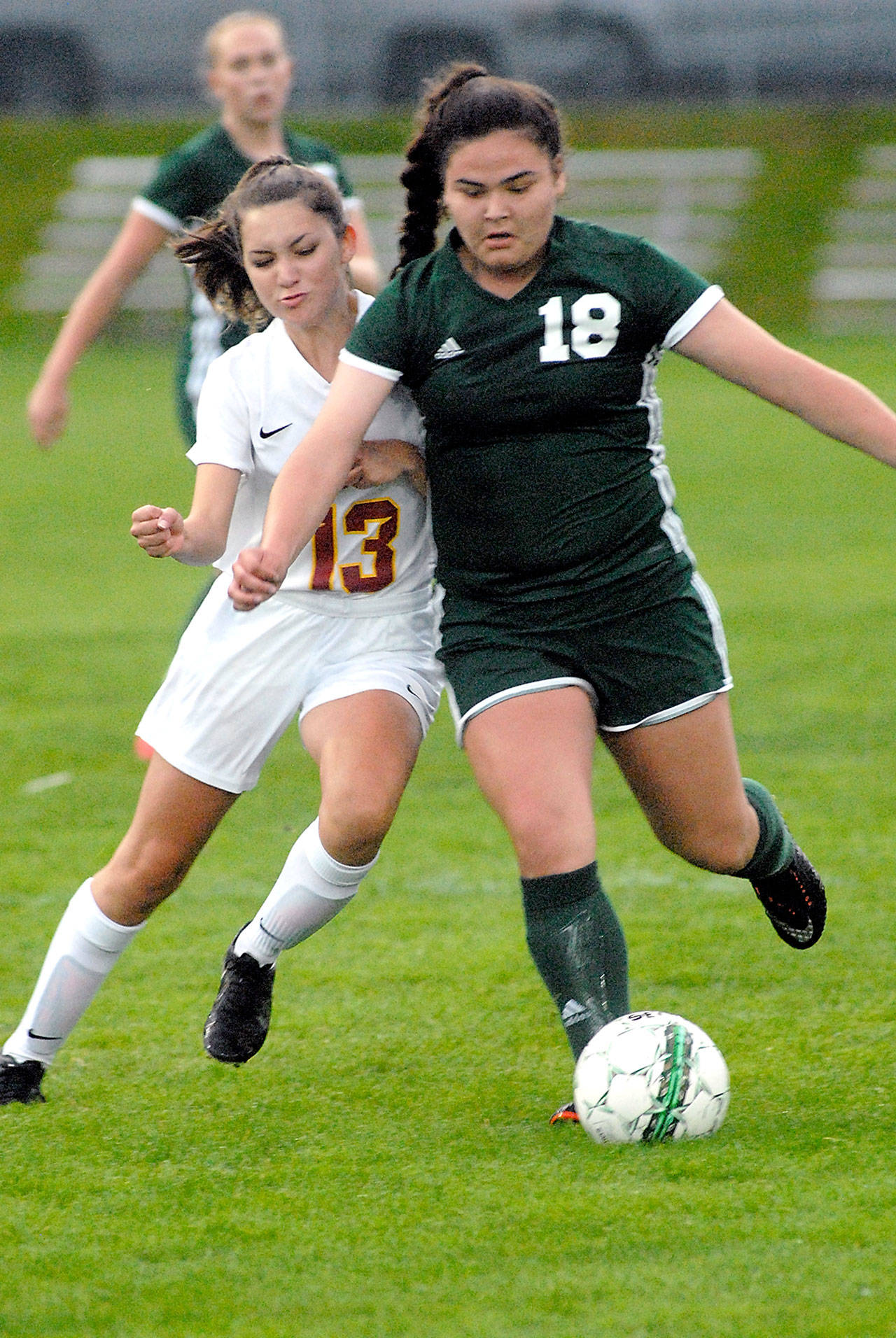 Keith Thorpe/Peninsula Daily News Port Angeles’ Kiana Watson-Charles, right, slips in front of Kingston’s Kylee Walker during first half play on Tuesday at Port Angeles Civic Field.