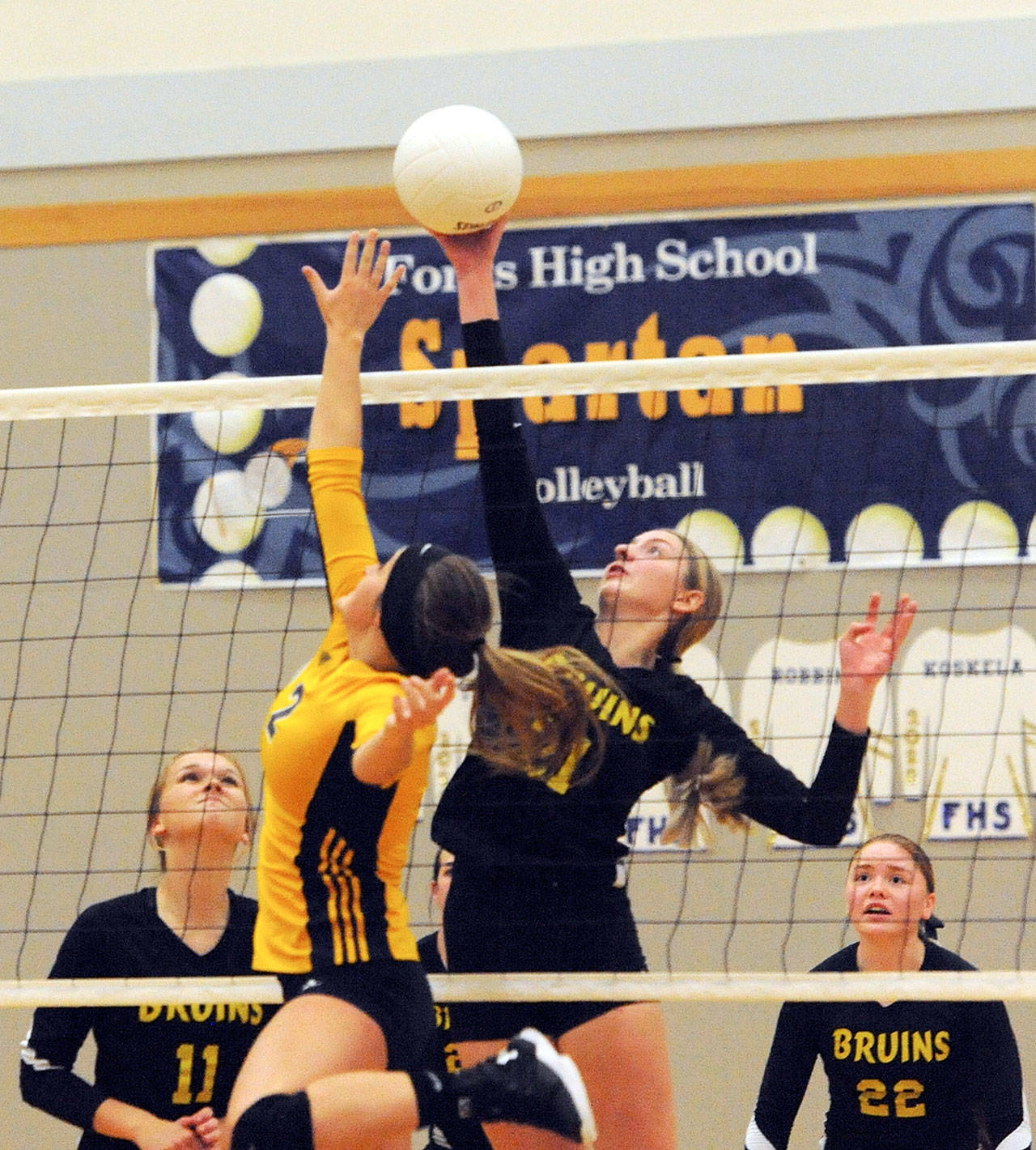image 10=Clallam Bay’s Miriam Wonderly challenges Spartan Julia Lausche (2) at the net Tuesday night in Forks where the Bruins defeated Forks three out of the five matches. Looking on for the Bruins are Kaitlynn Tyree (11) and Hannah Olson (22). Lonnie.