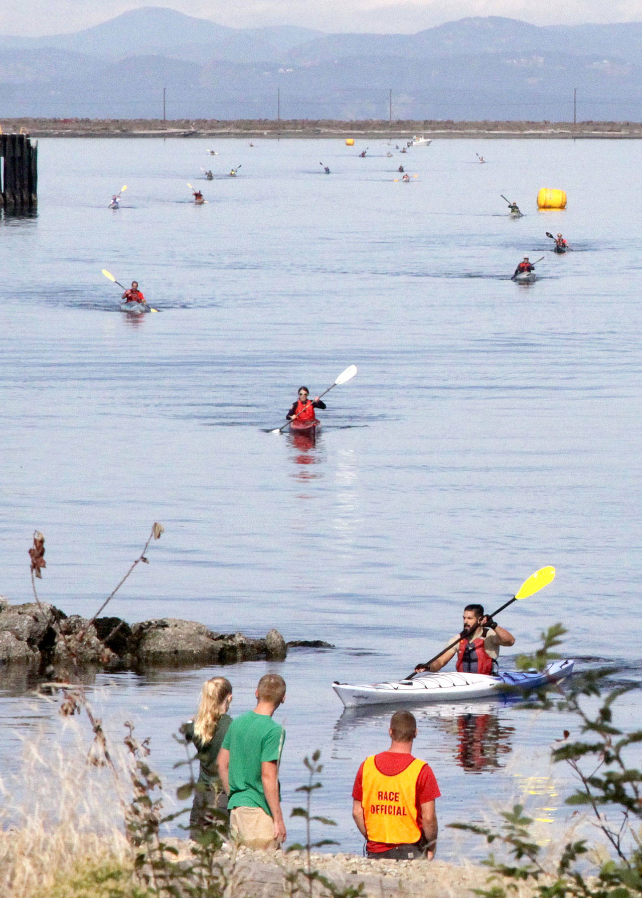 Dave Logan/for Peninsula Daily News Kayakers pull into shore during the second leg of the Big Hurt in 2017. Upon reaching shore, kayakers transitioned to a 30-mile bike ride.