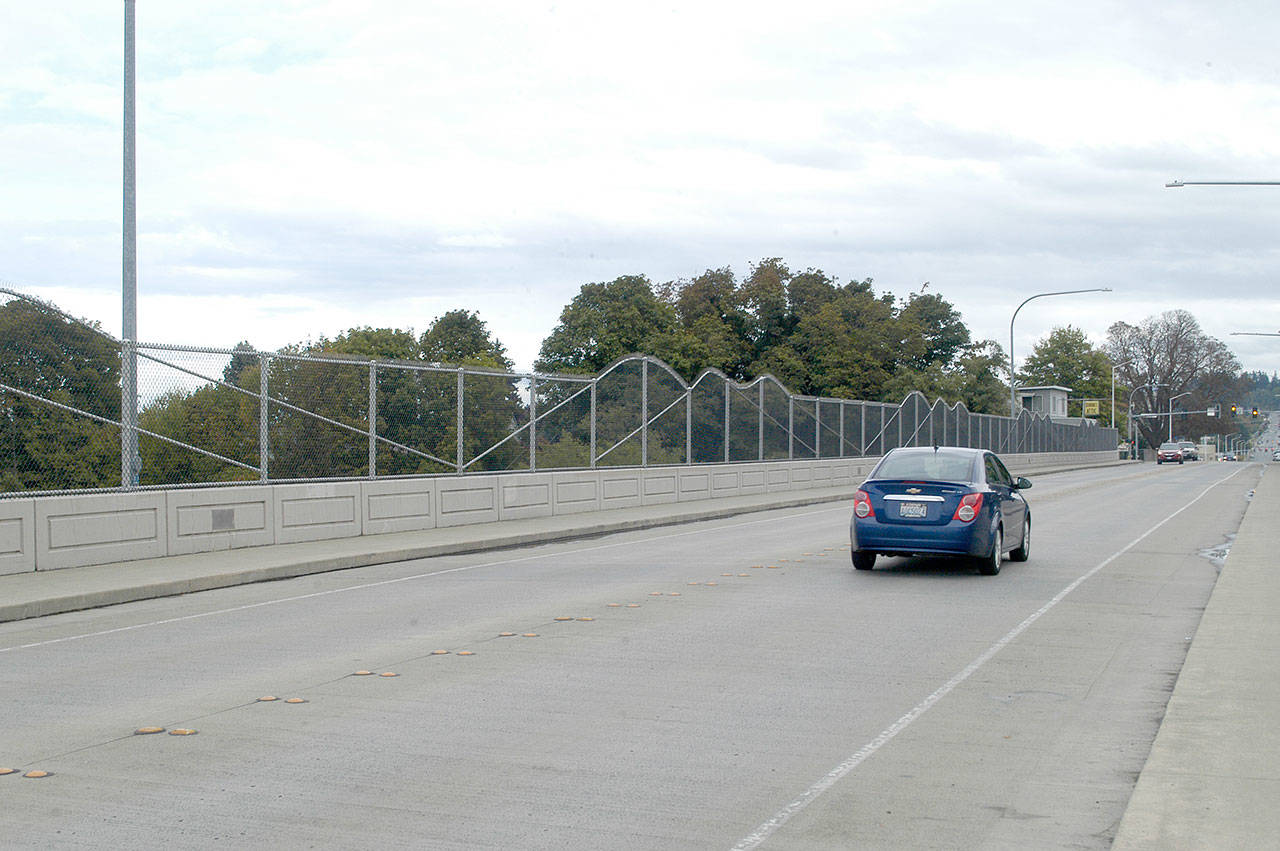 Motorists cross the eastern Eighth Street bridge Saturday, where a community block party will be held Wednesday. The program will begin at 5:30 p.m. Live bluegrass music will be played from 6 p.m. to 8 p.m. (Rob Ollikainen/Peninsula Daily News)