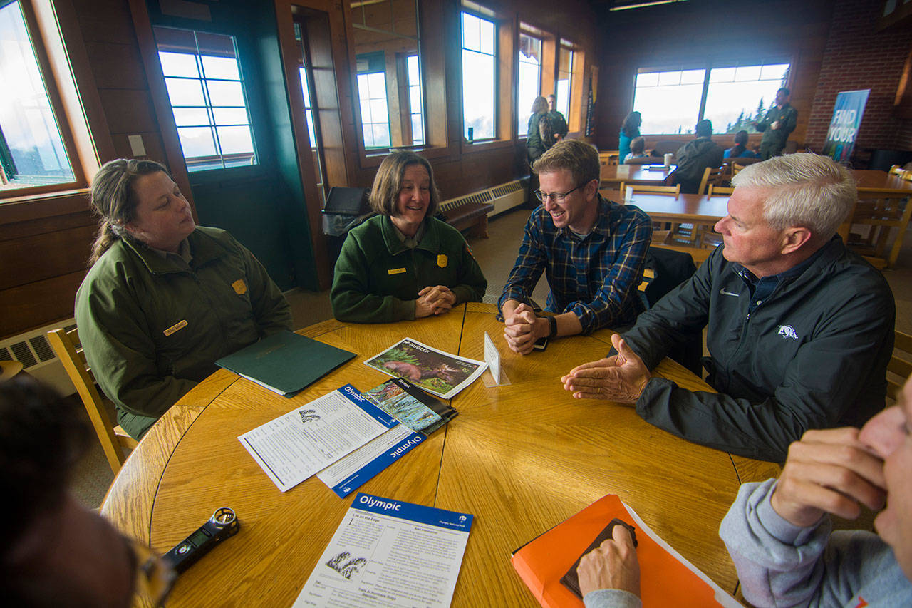 From left, Olympic National Park Spokesperson Penny Wagner, Deputy Superintendent Lee Taylor, U.S. Rep. Derek Kilmer, D-Gig Harbor, and U.S. Rep. Steve Womack, R-Ark., discuss issues that affect Olympic National Park at the Hurricane Ridge Visitor Center on Sunday. (Jesse Major/Peninsula Daily News)