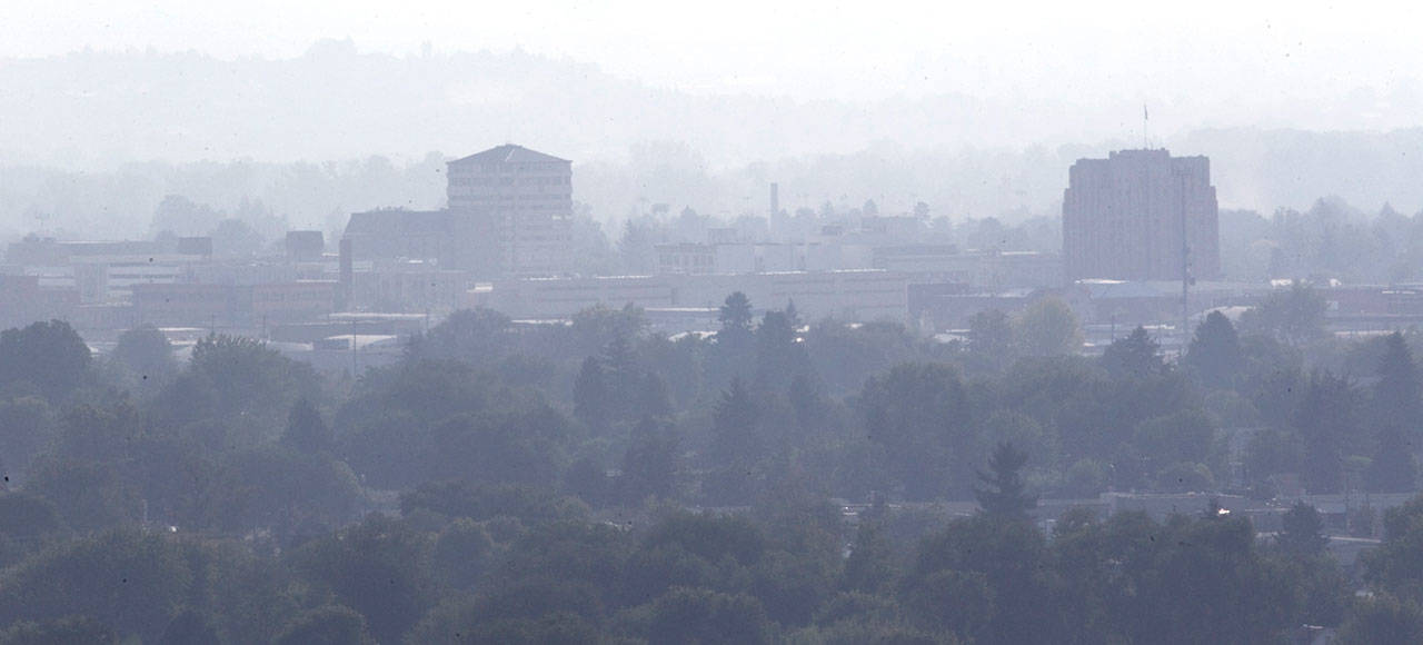 In this Sept. 20, 2012, file photo, a thick haze of smoke from wildfires inundates downtown Yakima. (Gordon King/Yakima Herald-Republic via AP)