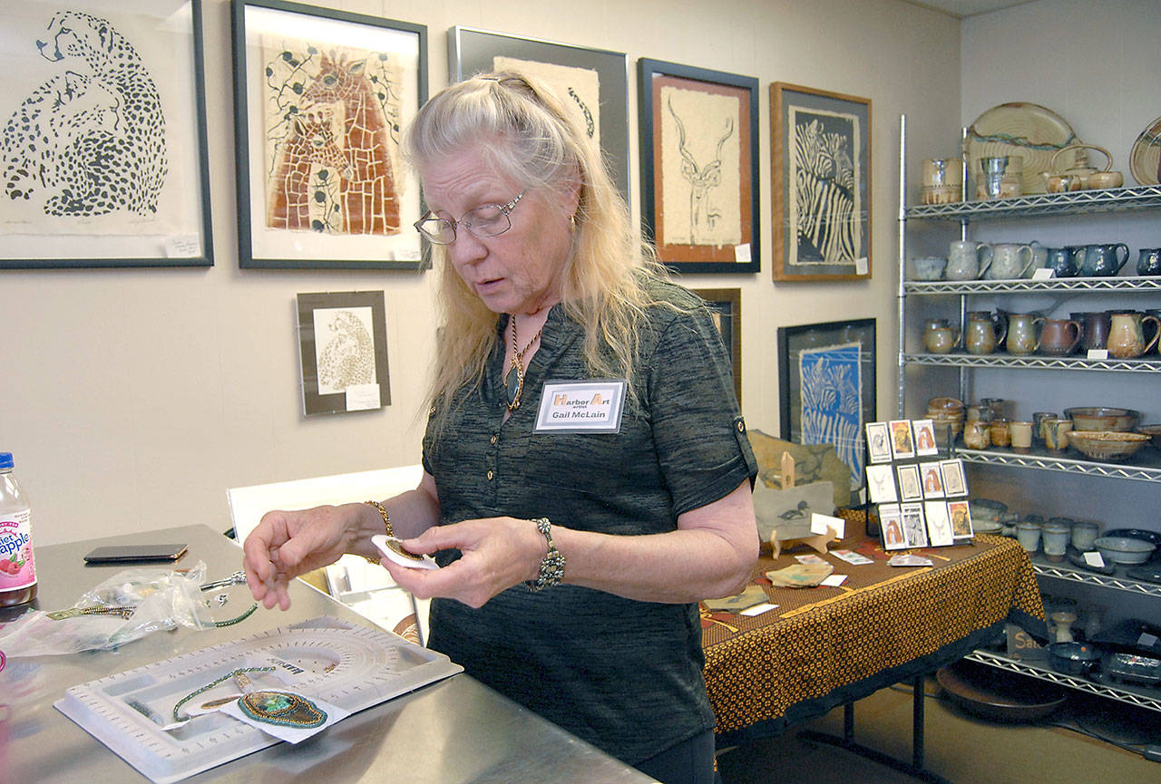 Sequim jewelry artist Gail McLain works on her craft at Harbor Art, 114 N. Laurel St., in downtown Port Angeles, a featured venue at this weekend’s Arts & Draughts Beer and Wine Festival. (Keith Thorpe/Peninsula Daily News)