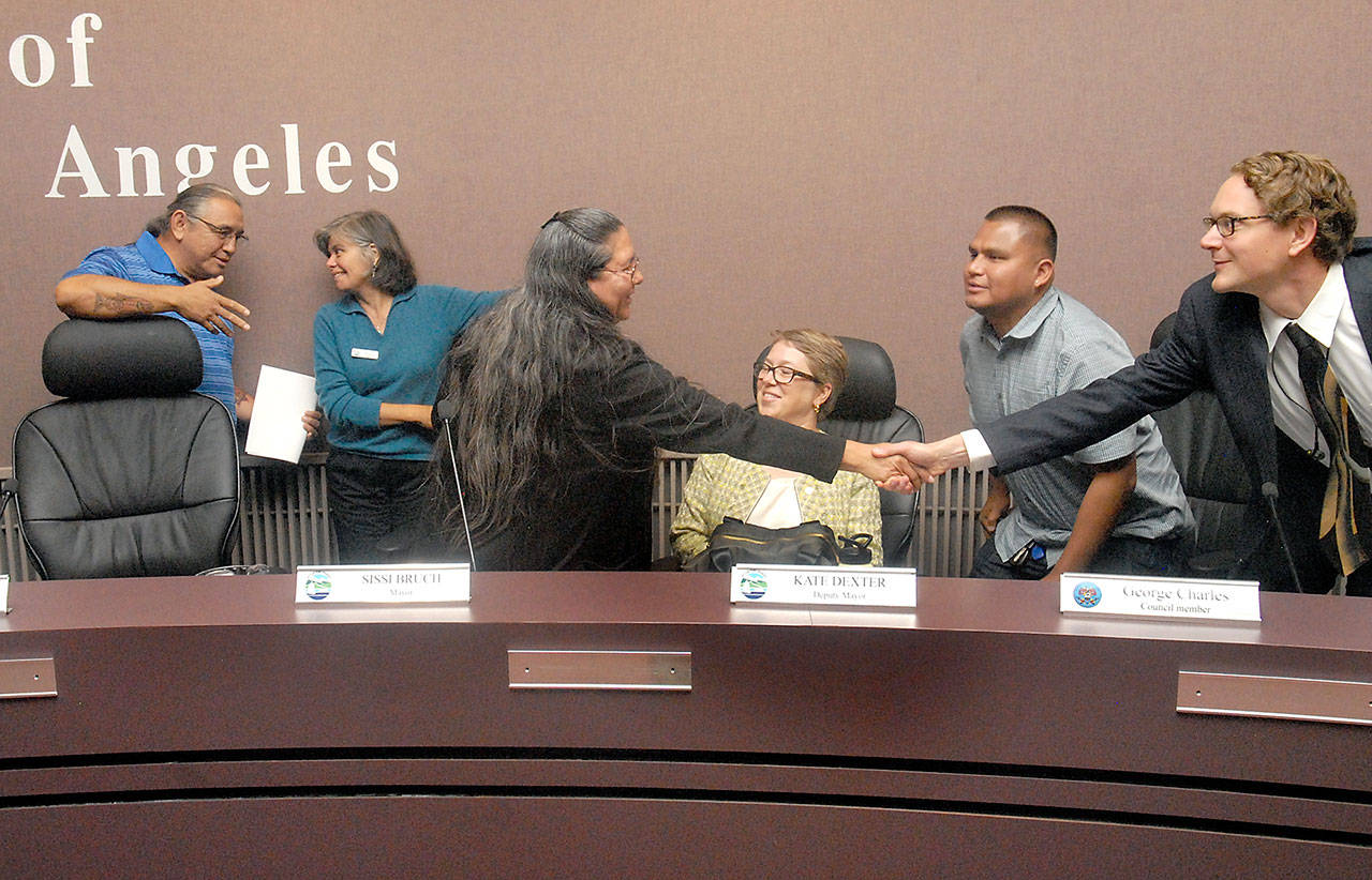 Members of the Port Angeles City Council and the Lower Elwha Klallam Tribal Council congratulate each other after reaching an agreement on Thursday for the tribe to purchase land to build a hotel in downtown Port Angeles. Among those present were, from left, tribal Vice Chairman Russell Hepfer, Mayor Sissi Bruch, tribal Chairwoman Frances Charles, Deputy Mayor Kate Dexter, tribal Council Member George Charles and city Council Member Lindsey Schromen-Wawrin. (Keith Thorpe/Peninsula Daily News)