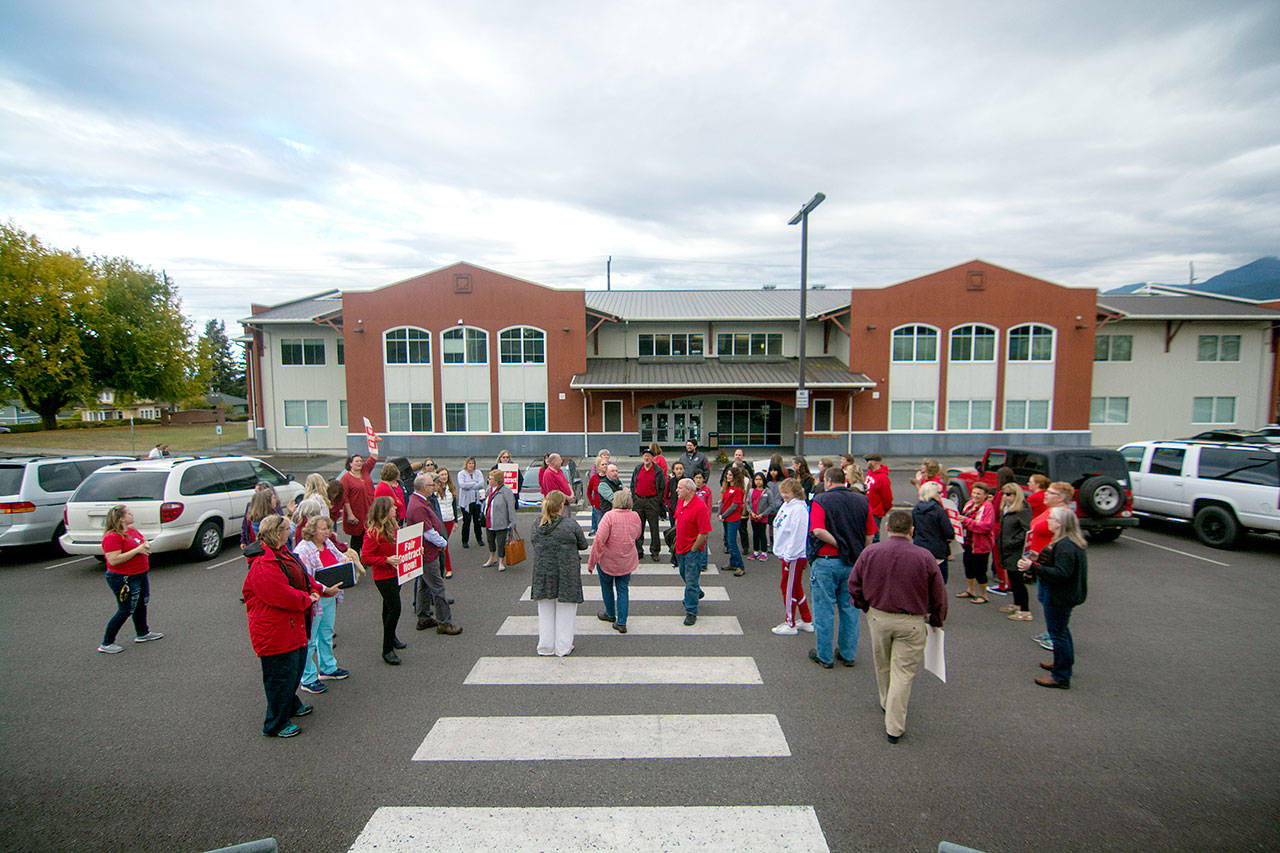 Port Angeles School District paraeducators and their supports rally outside the Lincoln Center ahead of a bargaining session with the school district Wednesday. (Jesse Major/Peninsula Daily News)
