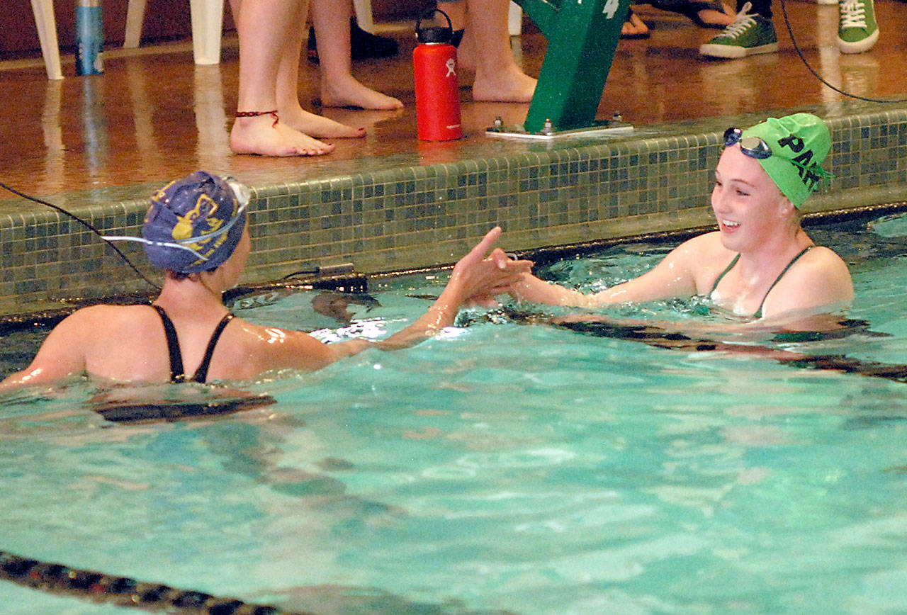 Keith Thorpe/Peninsula Daily News Port Angeles’ Nadia Cole, right, is congratulated by Sequim’s Mia Coffman after Cole took first in the 500-yard freestyle event with an unofficial time of 5:37.81 on Thursday at William Shore Memorial Pool in Port Angeles.