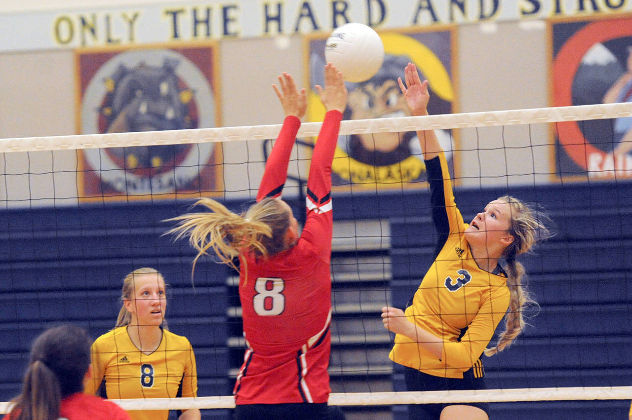 Lonnie Archibald/for Peninsula Daily News Forks Jayden Olson, right, challenges Teninos Olivia Hisaw at the net during the Spartans three-game sweep of the Beavers. Looking on is Forks Chloe Leverington.