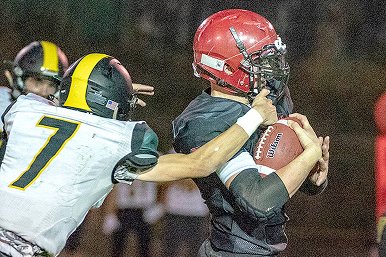 Port Townsend’s Dylan Tracer pulls Vashon defender Sol Dehnert while picking up a first down in a game on Friday at Memorial Field.                                Steve Mullensky/for Peninsula Daily News