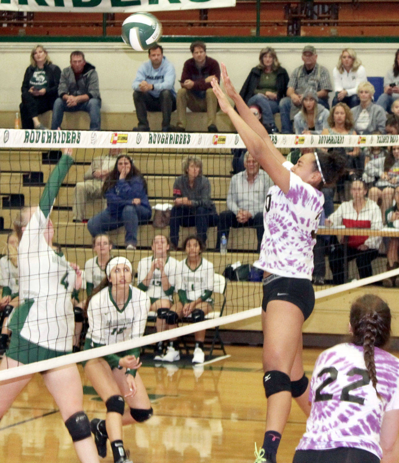 Sequim’s Jayla Julmist blocks a shot at the net against Port Angeles on Tuesday evening as teammate Tayler Breckenridge (22) is ready for a possible return. Julmist finished the match with seven blocks. Port Angeles players are McKenzie Musalek (4) and Jaida Wood (13). (Dave Logan /for Peninsula Daily News)