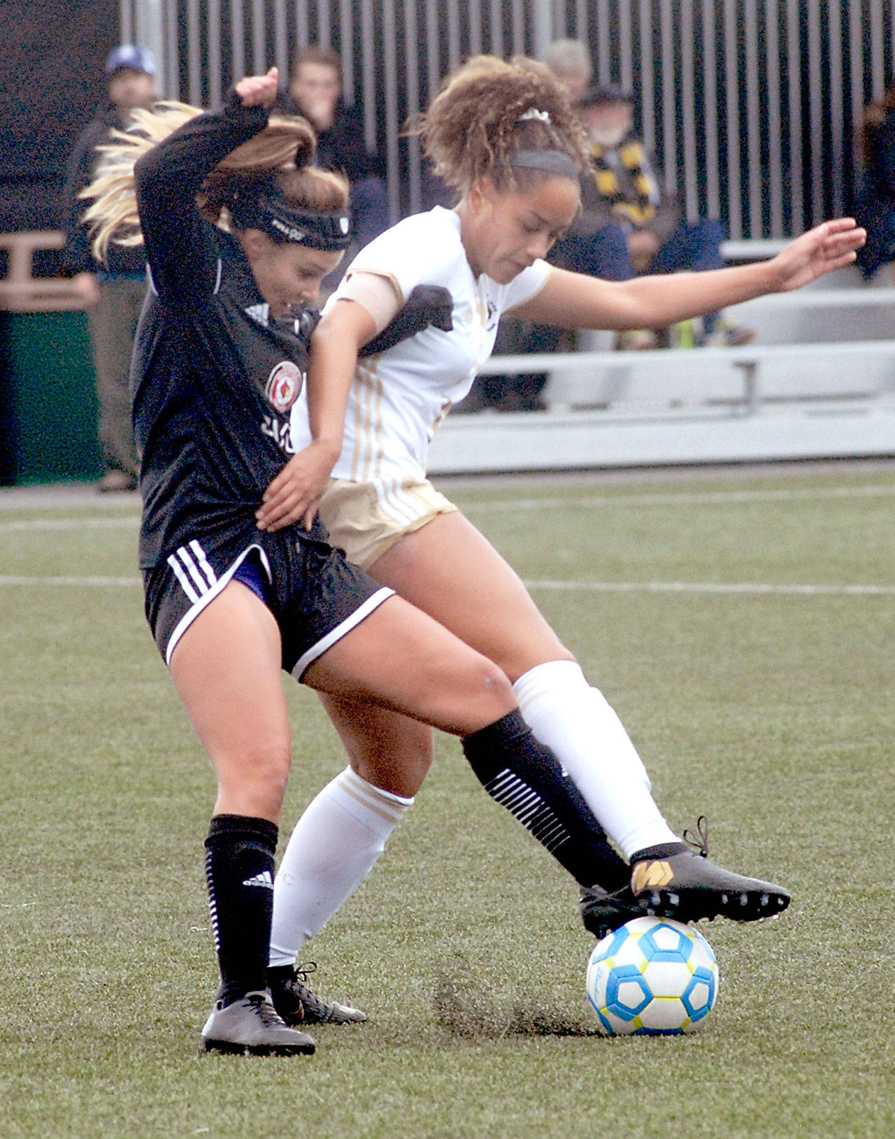 Keith Thorpe/Peninsula Daily News Skagit Valley’s Morgan Jones, left and Peninsula’s Halle Watson get tangled near midfield on Wednesday at Wally Sigmar Field in Port Angeles.