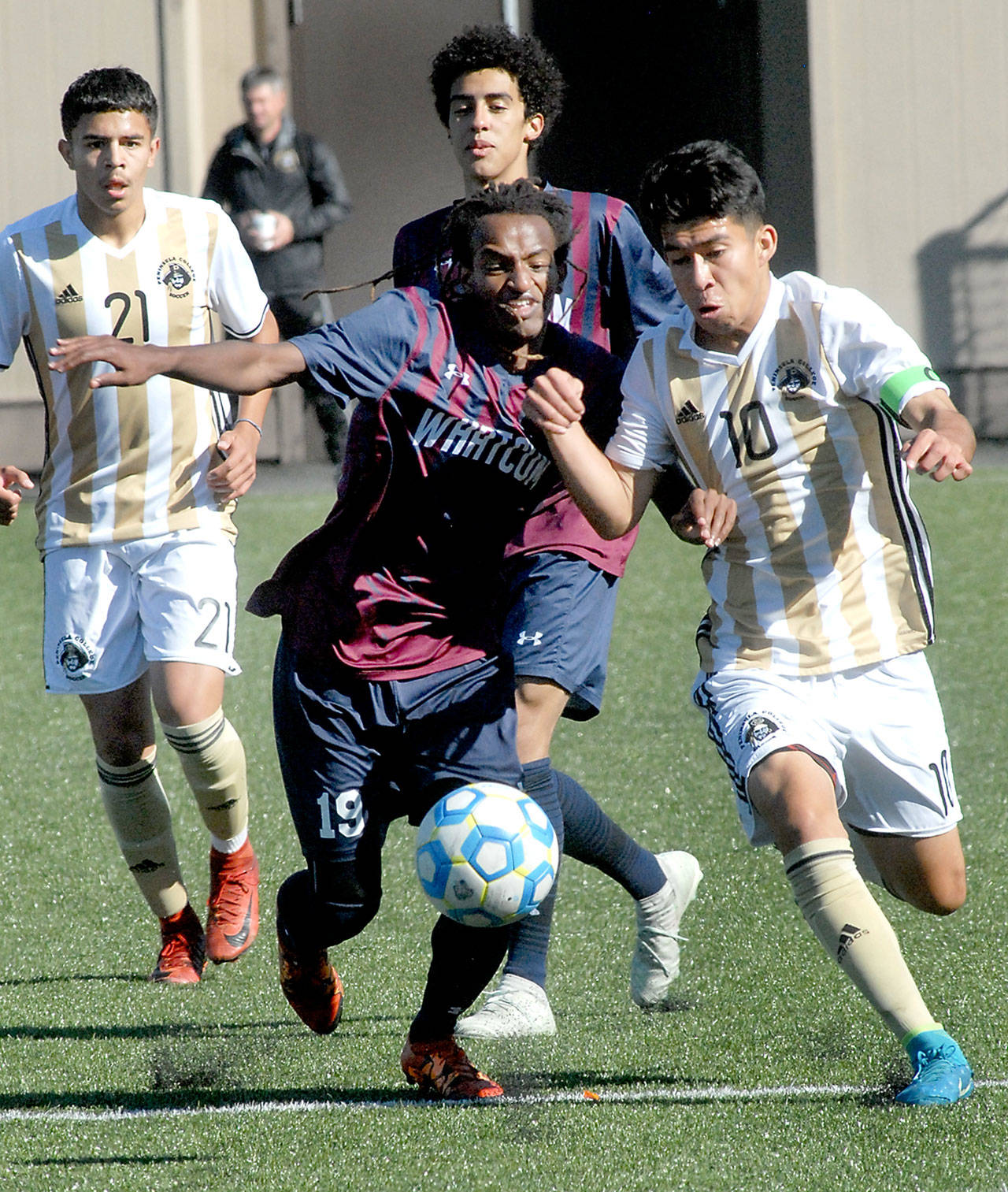 Keith Thorpe/Peninsula Daily News Whatcom’s Bekele Dowty, front left, and Peninsula’s Michael Benito battle for control during Saturday’s match at Wally Sigmar Field in Port Angeles. In the backround are Benito’s teammate, Edgar Tavares, left, and Whatcom’s Corey Williams.