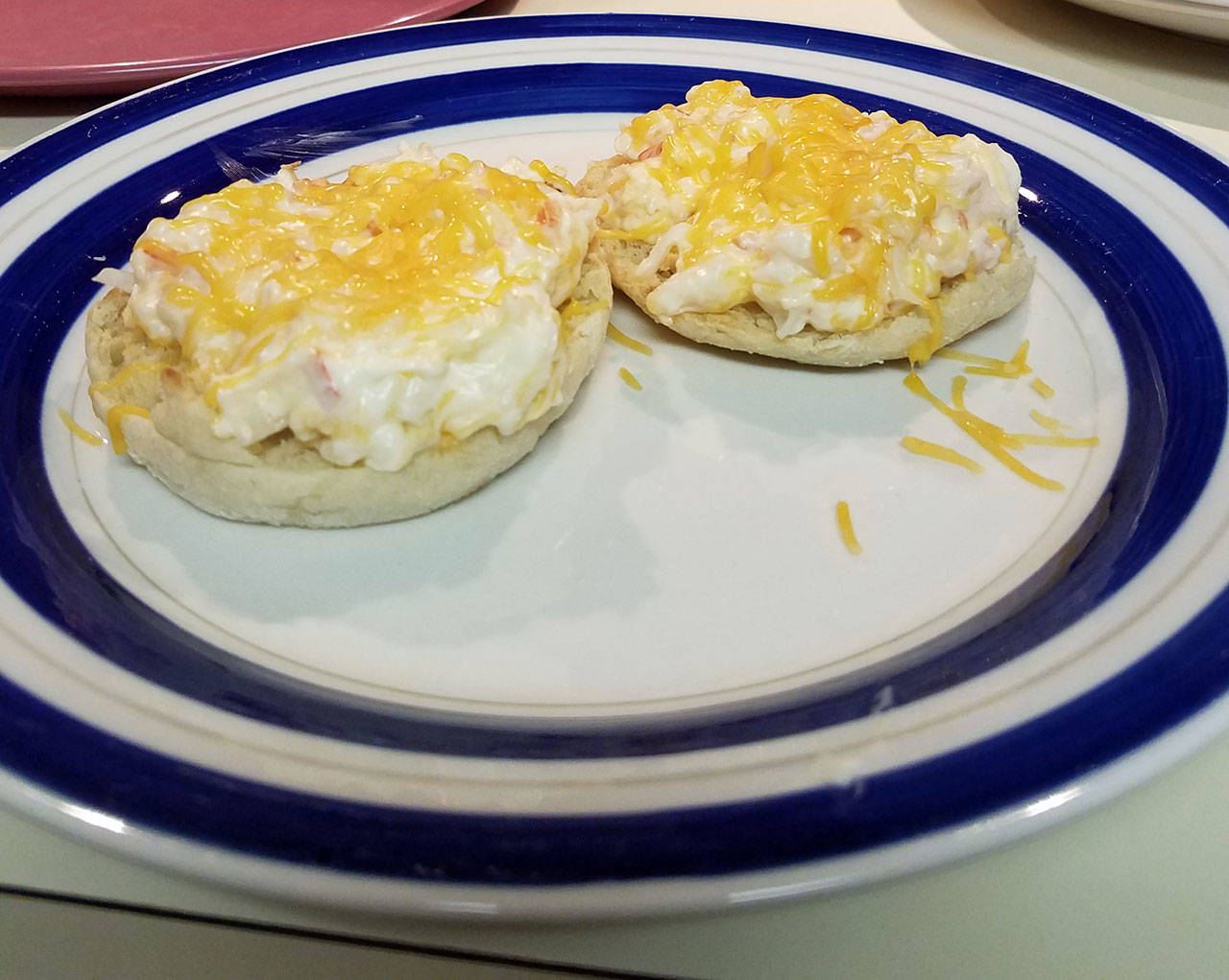 Hot crab dip sits on toasted English muffin halves awaiting a hungry mouth. (Emily Hanson/Peninsula Daily News)
