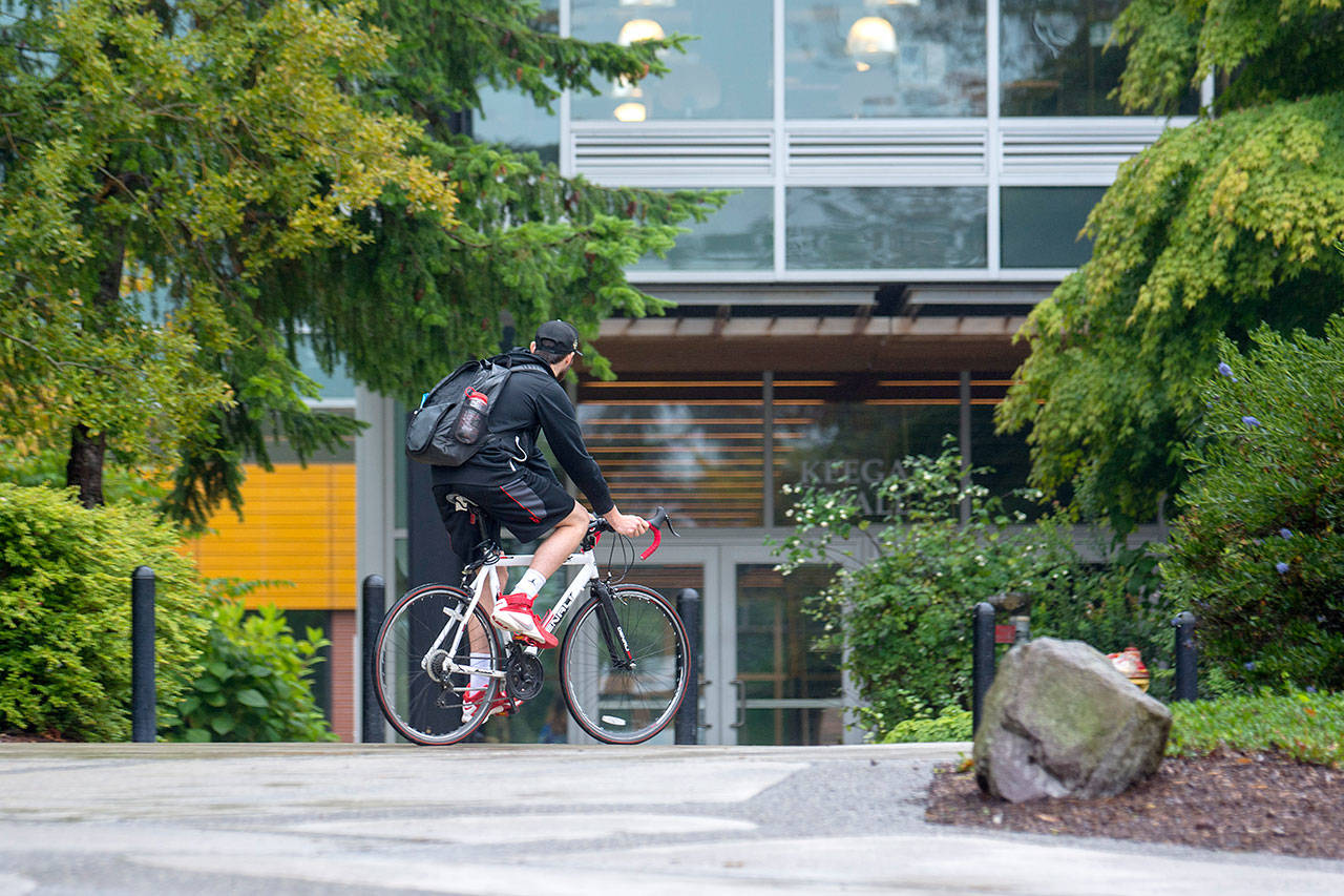 A cyclist makes his way across the Peninsula College campus in Port Angeles on Monday. Peninsula College announced Monday it will receive a $2.2 million grant from the federal Department of Education. (Jesse Major/Peninsula Daily News)