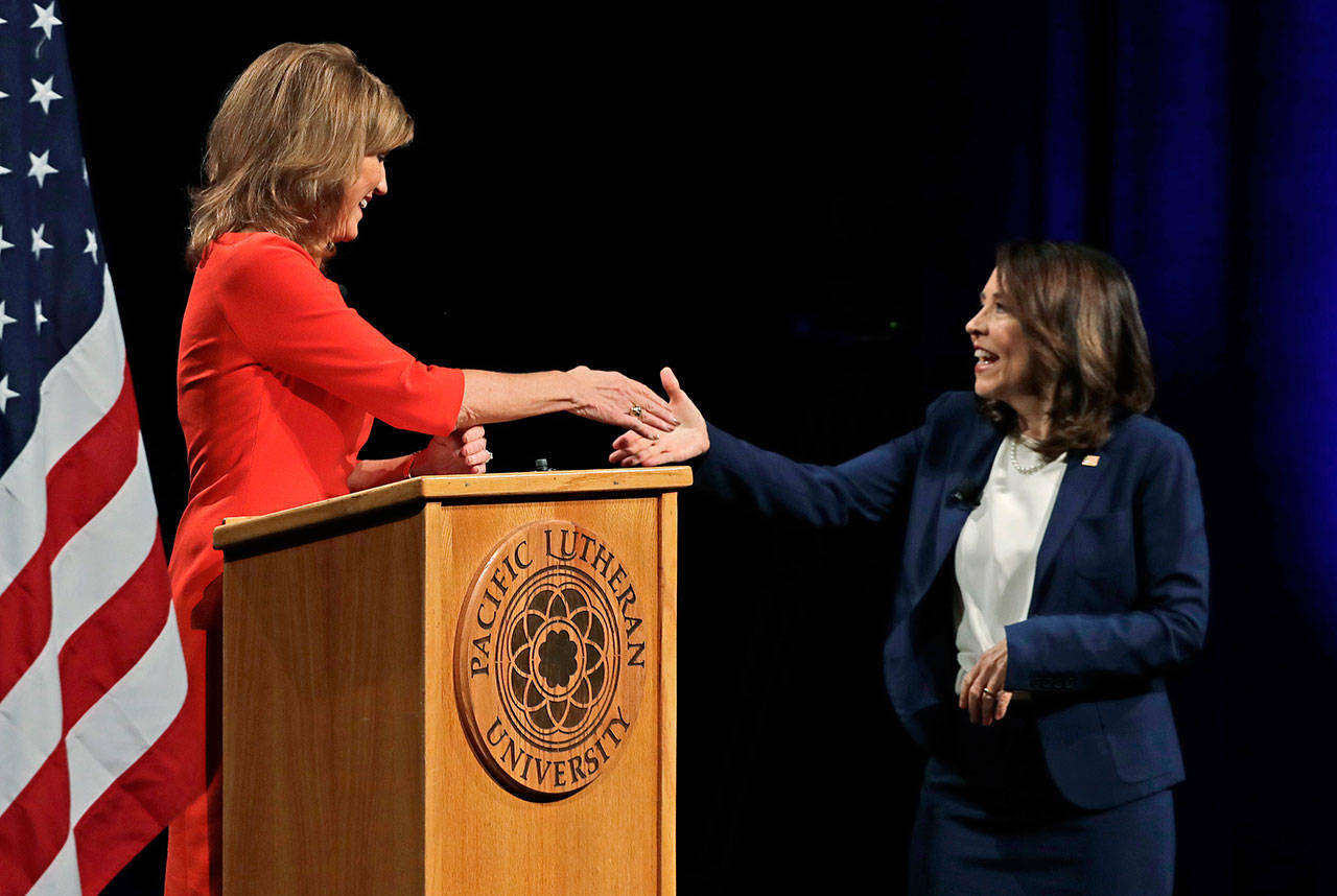 Sen. Maria Cantwell, D-Wash., right, shakes hands with her Republican challenger, Susan Hutchison, on Monday following a debate at Pacific Lutheran University in Tacoma. (Ted S. Warren/The Associated Press)