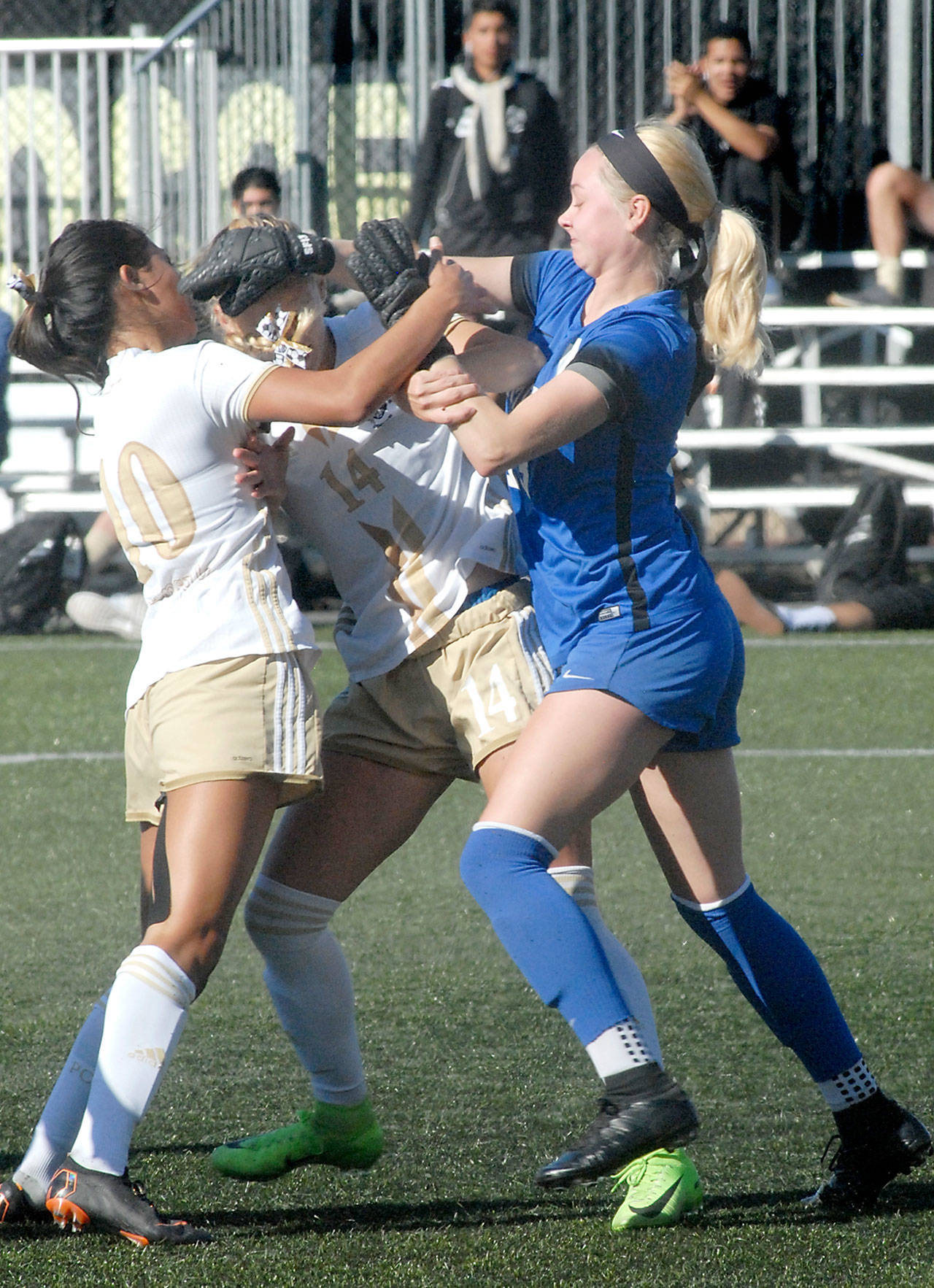 Keith Thorpe/Peninsula Daily News Peninsula’s Shantel Torrres-Benito, left, tries to break up an altercation betwen teammate Taylor Graham and Edmonds goalkeeper Samantha Miller-Foy, right, after a Peninsula goal in the first half on Wednesday at Wally Sigmar Field. Miller-Foy was shown a yellow card in the incident.