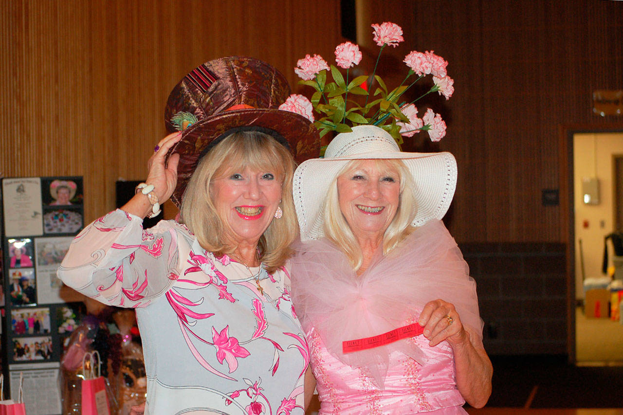 Locals Kathryn Haskell, left, and her friend Marian Fine, sport their “pretty in pink” attire and creative hats at the 21st annual Mad Hatters Tea party and luncheon Oct. 5. (Erin Hawkins/Olympic Peninsula News Group)