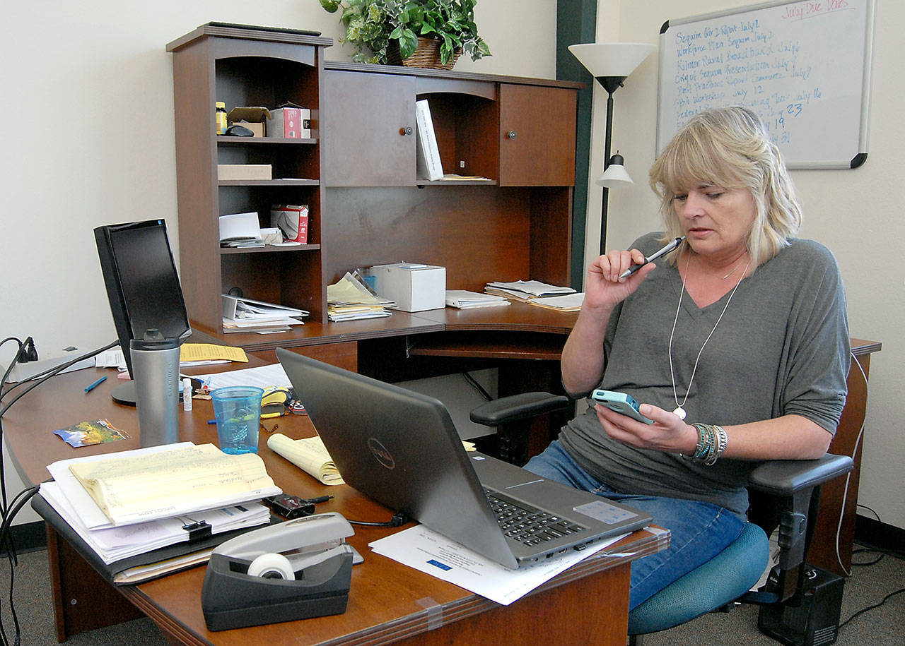 Clallam Economic Development Corp. Executive Director Julie Knott receives a telephone inquiry in her office at the Lincoln Center in Port Angeles. (Keith Thorpe/Peninsula Daily News)