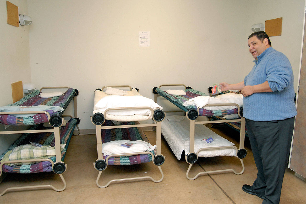 Manny Aybar, director of shelter services for Serenity House of Clallam County, shows off accommodations that overnight visitors receive at the organization’s single adult shelter in Port Angeles. (Keith Thorpe/Peninsula Daily News)