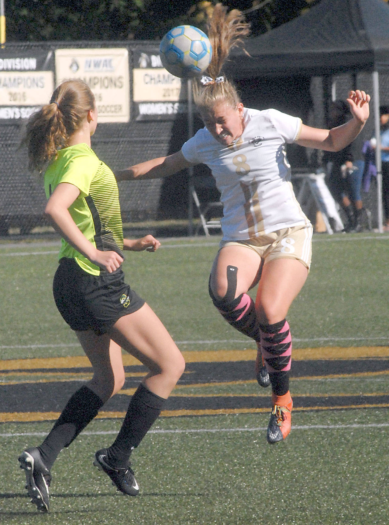 Keith Thorpe/Peninsula Daily News Peninsula’s Emilee Greve, right, takes the header in front of Shoreline’s Courtney Wagner on Saturday at Wally Sigmar Field in Port Angeles.