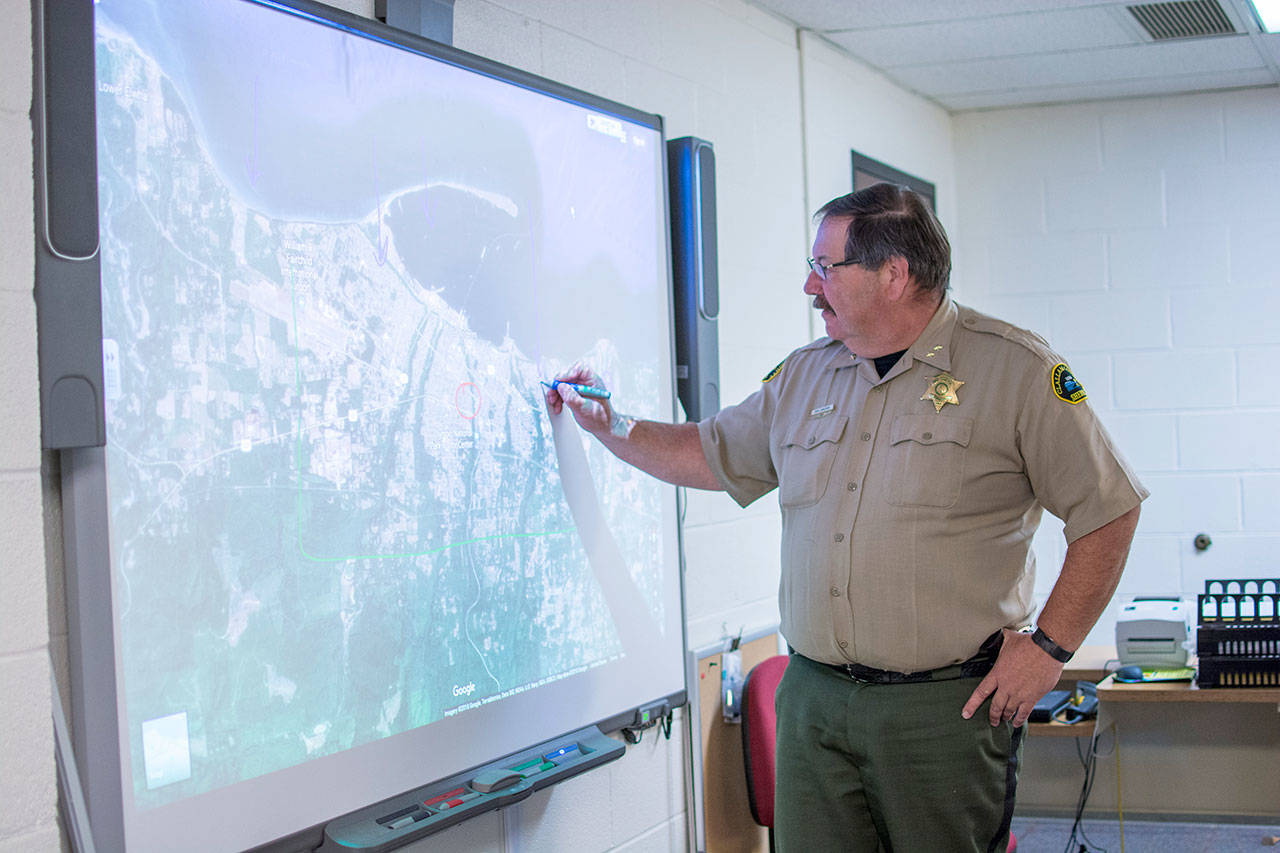 Clallam County Undersheriff Ron Cameron demonstrates how to use the smart board in the county’s Emergency Operations Center on Monday. On Thursday, the county will participate in the Great Washington ShakeOut. (Jesse Major/Peninsula Daily News)