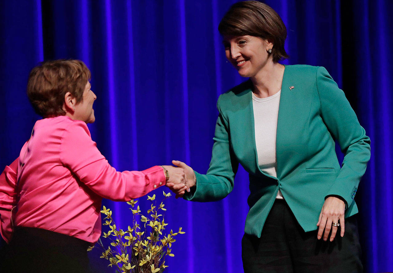 U.S. Rep. Cathy McMorris Rodgers, R-Spokane, right, shakes hands with Lisa Brown, left, her Democratic challenger, following a debate Sept. 19 in Spokane. (Ted S. Warren/The Associated Press)