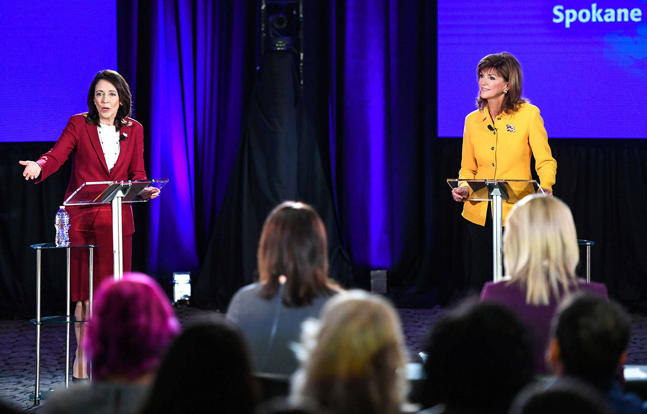 Democratic U.S. Sen. Maria Cantwell, left, and Republican challenger Susan Hutchison answer questions about climate change during a debate at Spokane Community College on Saturday. (Dan Pelle/The Spokesman-Review via AP)