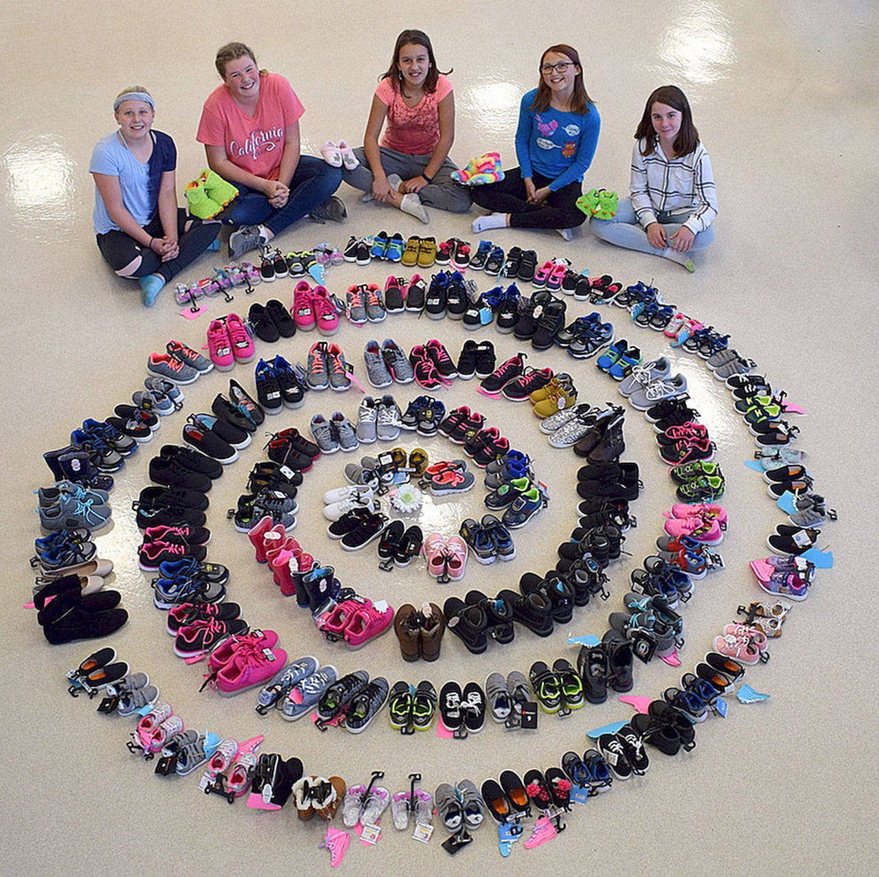 Girl Scouts with Troop 45181, from left, Adrianna Delph, Paige Krzyworz, Mia Kirner, Alexys Amaya and Izzy Taylor helped bring in more than 130 pairs of new shoes for Clallam County foster children through a recent shoe drive. Not pictured are Desirea and Mya Spalding.