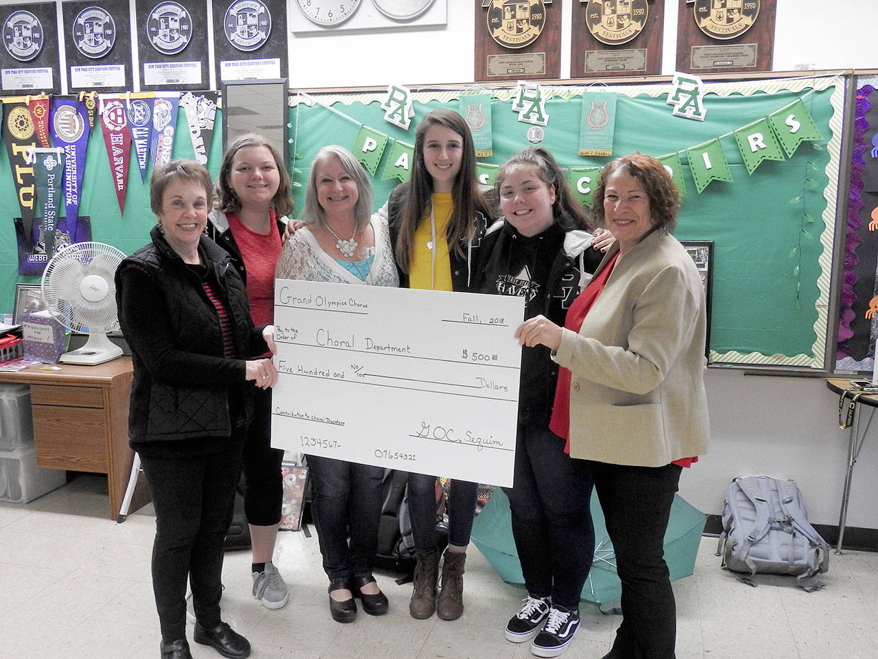 Grand Olympics Chorus recently presented the Port Angeles High School Chorus program with a $500 donation for their upcoming New York trip. Shown are Gay Lyn Lillagore, Trinadey Colville and director Jolene Gailey of Grand Olympics Chorus; Madelynne Jones and Kenzie Carney of Belle Voce Chorus; and Jean McDonald of Grand Olympics Chorus.