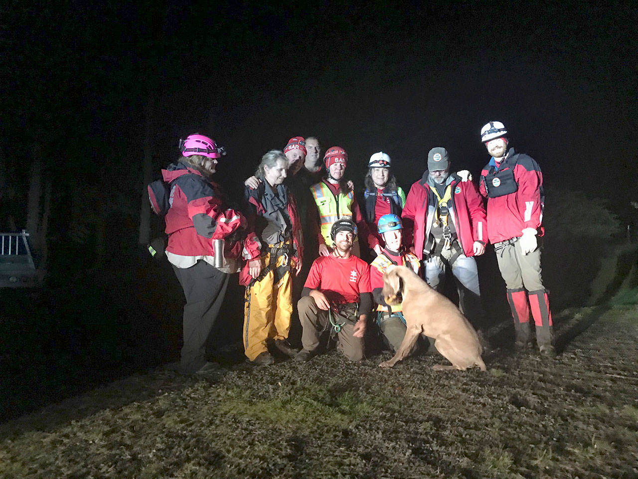 Clallam County Sheriff’s Office Search and Rescue Team members stand with a 70-pound dog they rescued from a bluff west of Port Angeles on Wednesday. (Clallam County Sheriff’s Office)