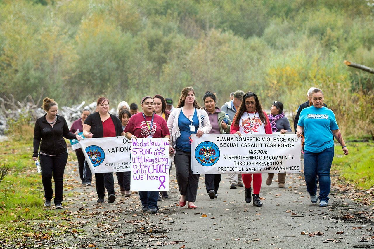 Members of the Lower Elwha Klallam Tribe participate in a domestic violence awareness walk Wednesday evening. (Jesse Major/Peninsula Daily News)