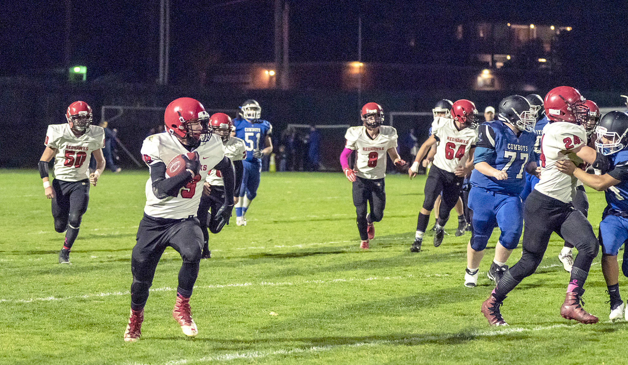 &lt;strong&gt;Steve Mullensky&lt;/strong&gt;/for Peninsula Daily News                                The Redhawk offense clears a path for Cole Crawford to gain yardage for a first down during a game against Chimacum on Friday in Memorial Field.