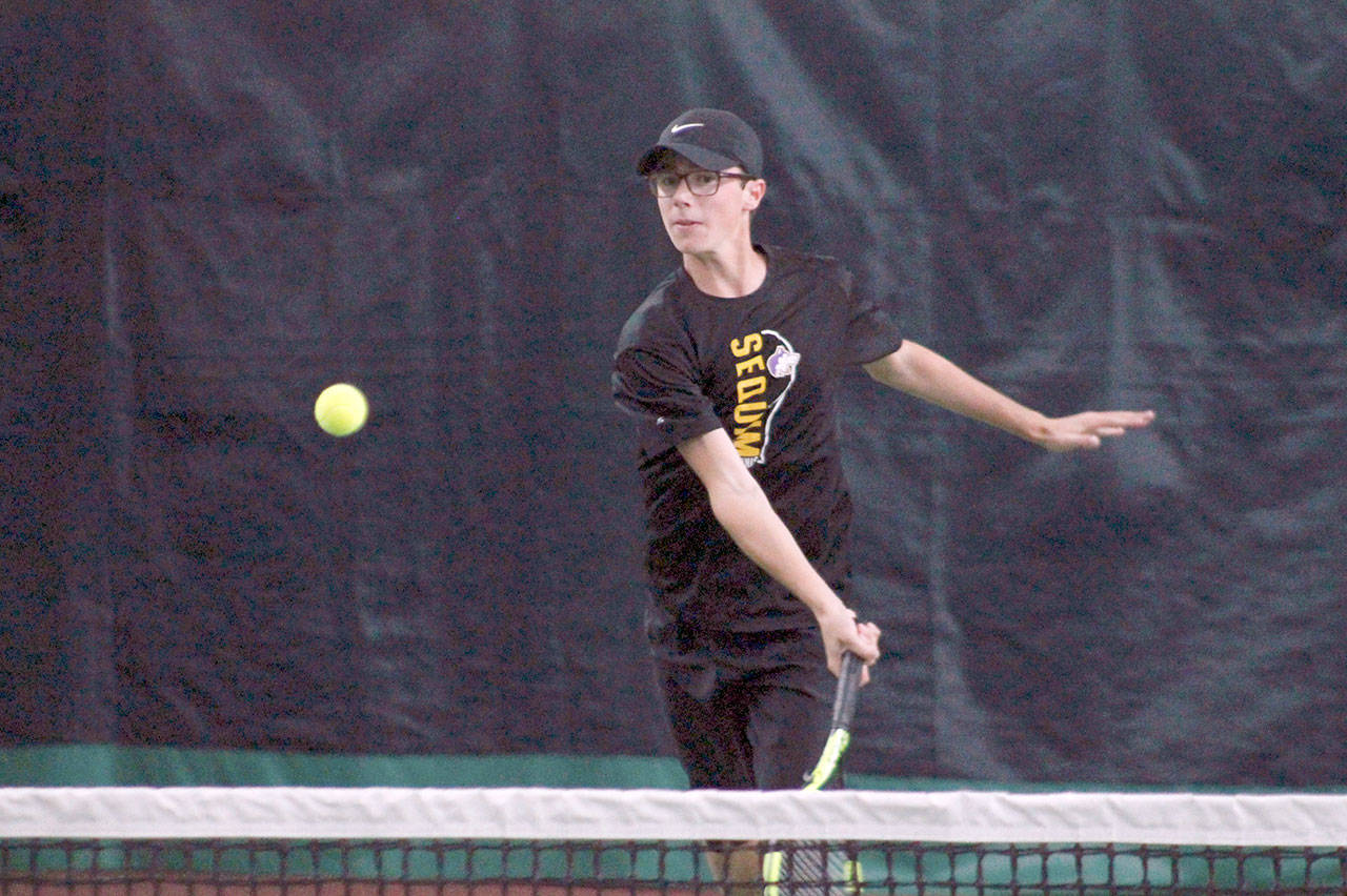 Mark Krulish/Kitsap News Group Sequim’s Damon Little returns a shot during a West Central District Tournament doubles match at Kitsap Tennis and Athletic Center in Bremerton. Little and partner Liam Payne finished third and qualified for the state tournament in May.
