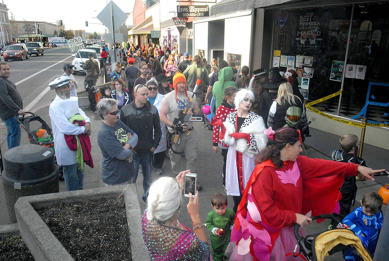 Children and adults make the rounds of downtown Port Angeles businesses searching for treats during last year’s Halloween celebration. (Keith Thorpe/Peninsula Daily News)