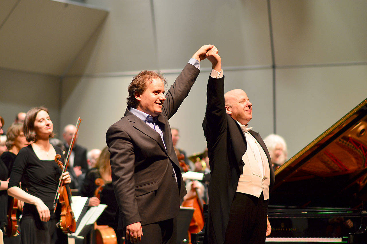 Pianist Josu de Solaun, left, and conductor Jonathan Pasternack take the first of many bows at their spring 2016 concert. The pair reunites for a performance with the Port Angeles Symphony on Saturday. (Diane Urbani de La Paz/for Peninsula Daily News)