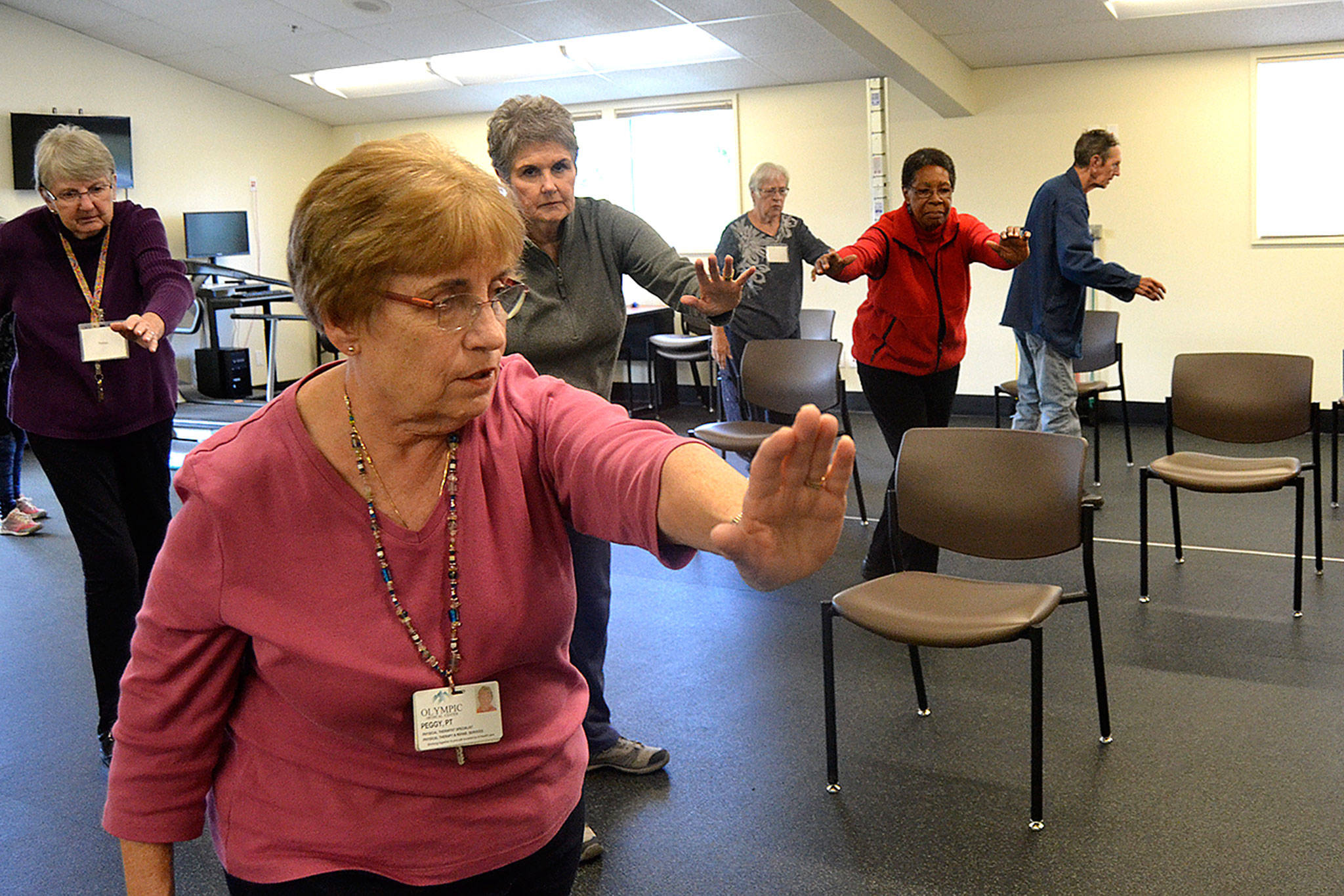 Tai Ji Quan continues at the YMCA through Olympic Medical Center’s Wellness Services program. Here, participants, from left, Helen Butler, physical therapist Peggy Scheideler, Sandy Sullivan, Sarah Thomas, Peggy Dawson, and Richard Thomas move together in the 23rd week of a 24 week class to help prevent falls. (Matthew Nash/Olympic Peninsula News Group)