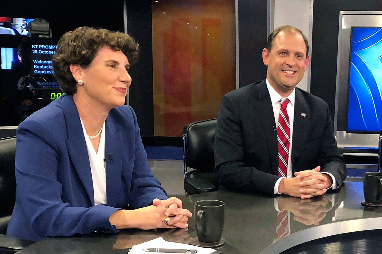 Kentucky’s 6th Congressional District candidates Amy McGrath and Andy Barr pose for photos before the start of a debate in Lexington, Ky., on Oct. 29. Barr, the Republican incumbent, faces a tough challenge from McGrath, a Democrat. (Adam Beam/The Associated Press)