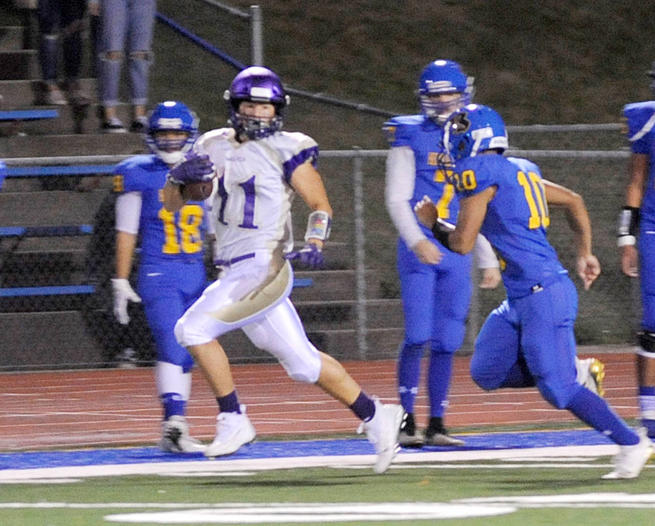 Michael Dashiell/Olympic Peninsula News Group Sequim’s Michael Young, left, runs away from the Bremerton defense during the Wolves 41-21 win earlier this season.