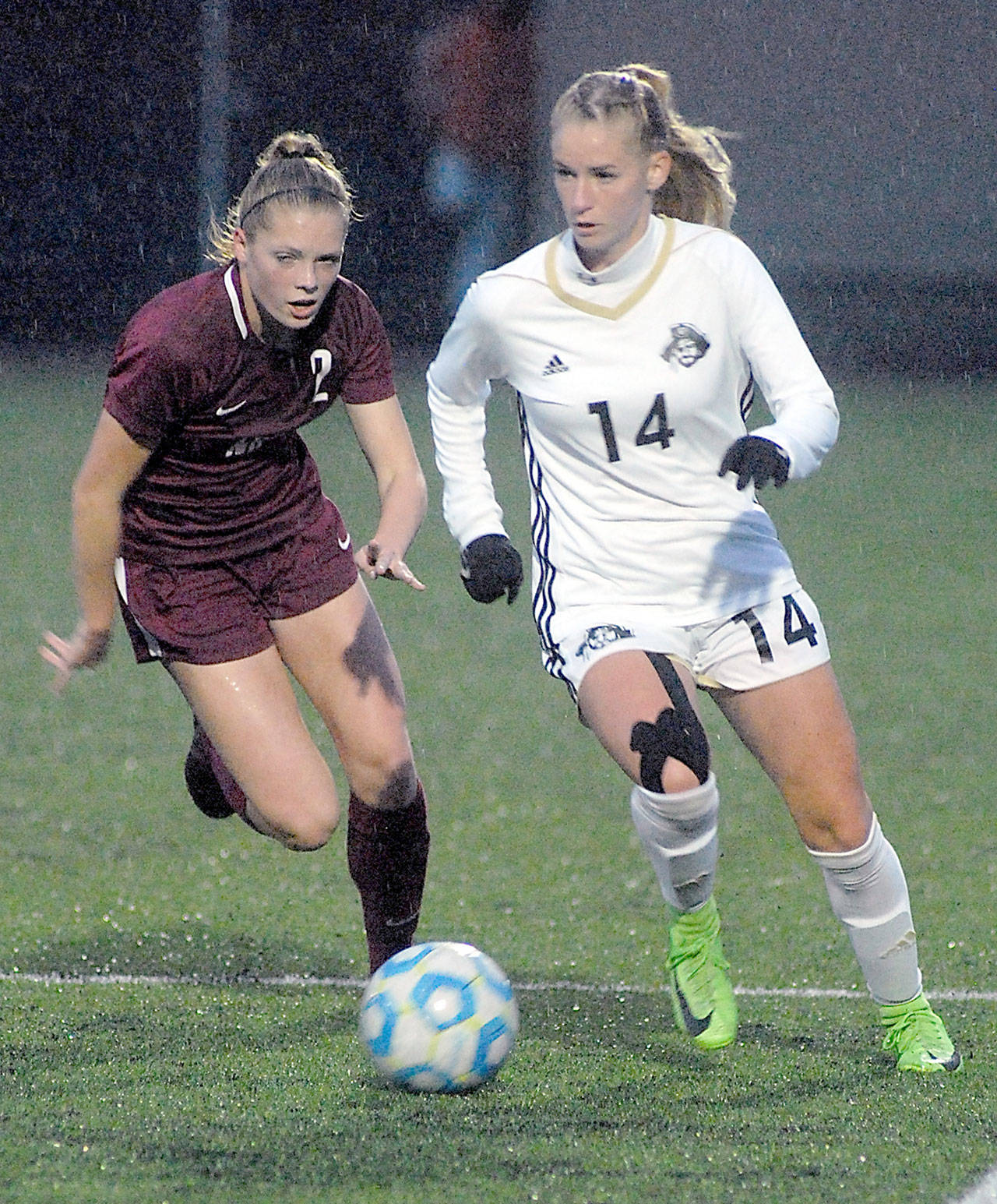 Peninsula’s Taylor Graham, right, slips past the defense of North Idaho’s Breanne Kuni during their NWAC quarterfinal match on Saturday under the lights at Wally Sigmar Field in Port Angeles. (Keith Thorpe/Peninsula Daily News)