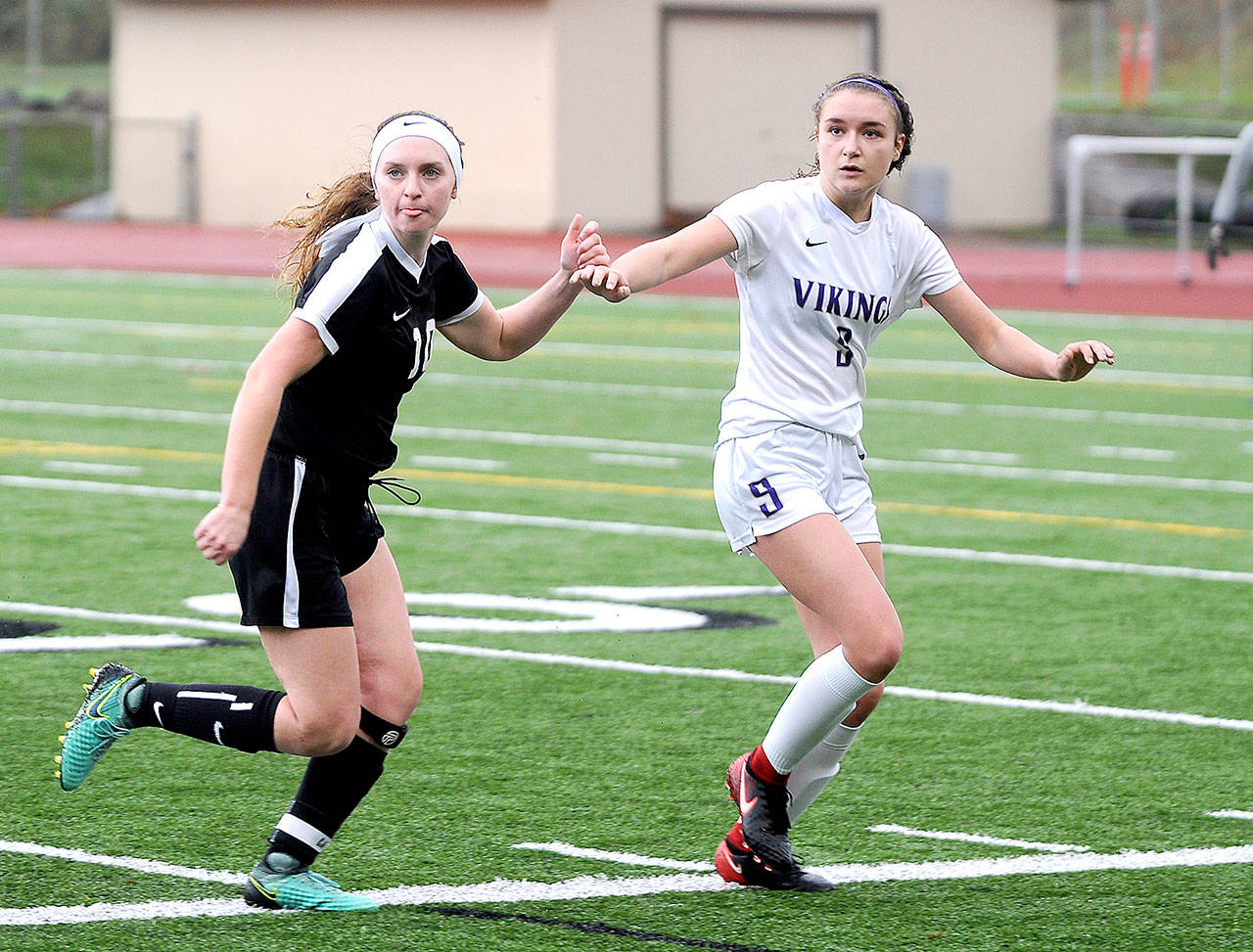 Sequims Gabby Happe, left, battles for position with North Kitsaps Charlotte Bond in the West Central District III championship Sarturday in Silverdale. Sequim won 1-0 to take the championship. (Michael Dashiell/North Olympic News Group)